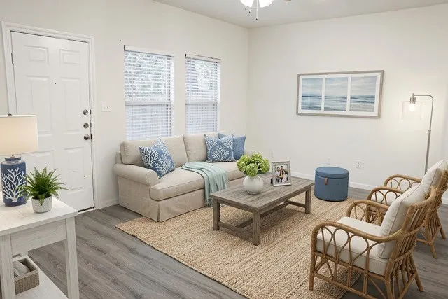 Living area featuring wood-finish flooring and ample natural light from two windows