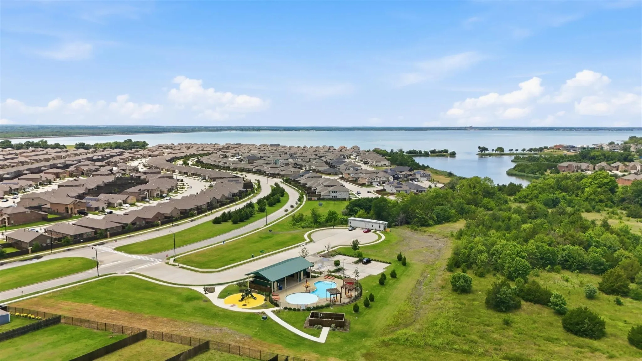 Pool #2, brand new, with playground and shallow end for kids. Just steps from beautiful Lake Ray Hubbard fishing access. Future plans include a walking path down to the water.