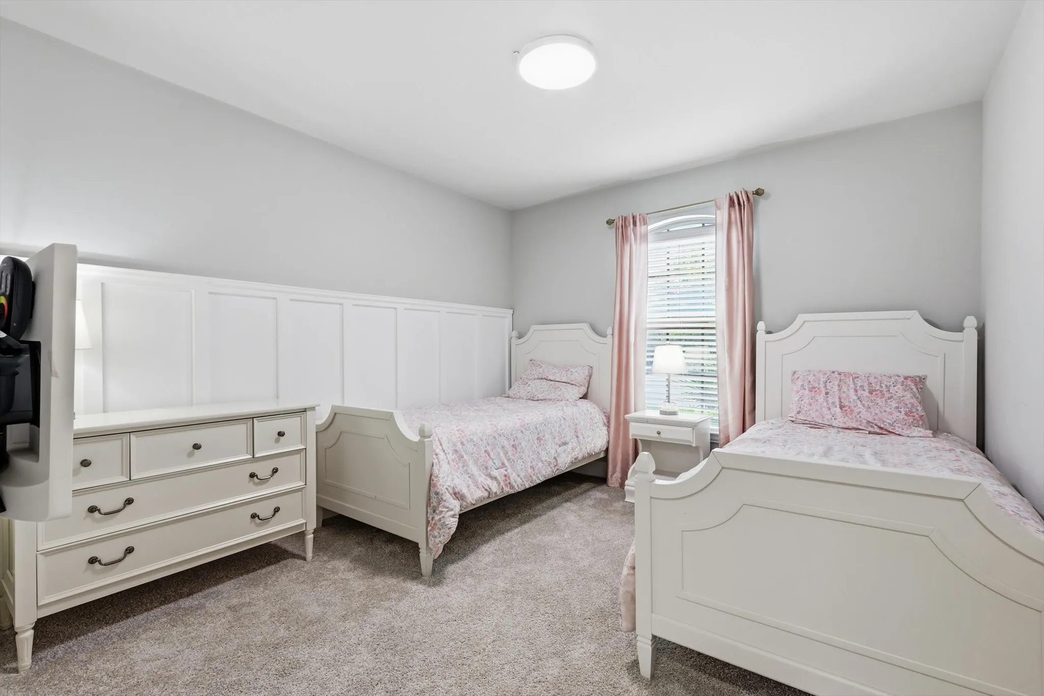 Neutral gray wall finishes complementing soft gray carpeting