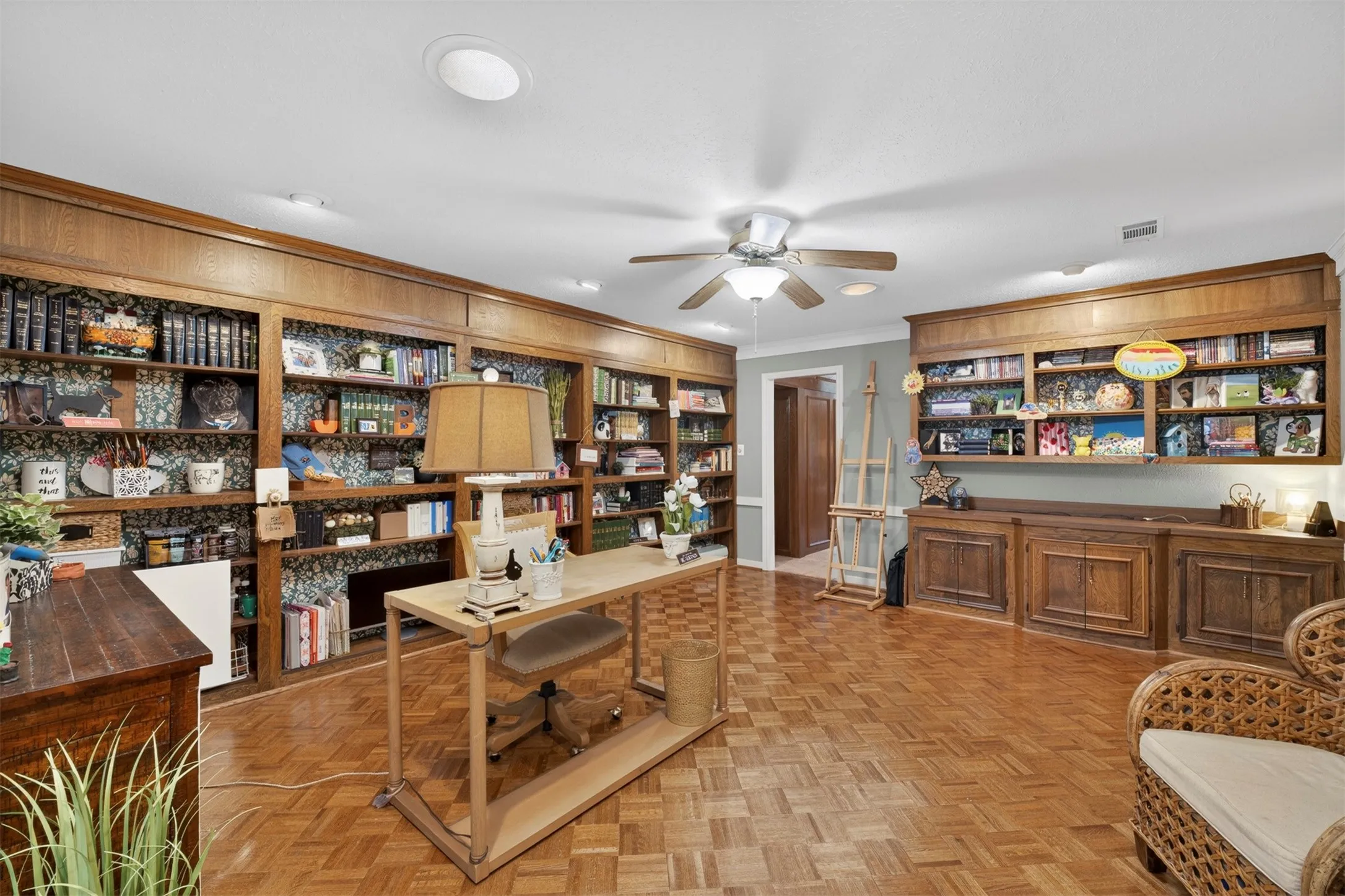 Expansive room featuring extensive built-in wooden shelving and cabinetry