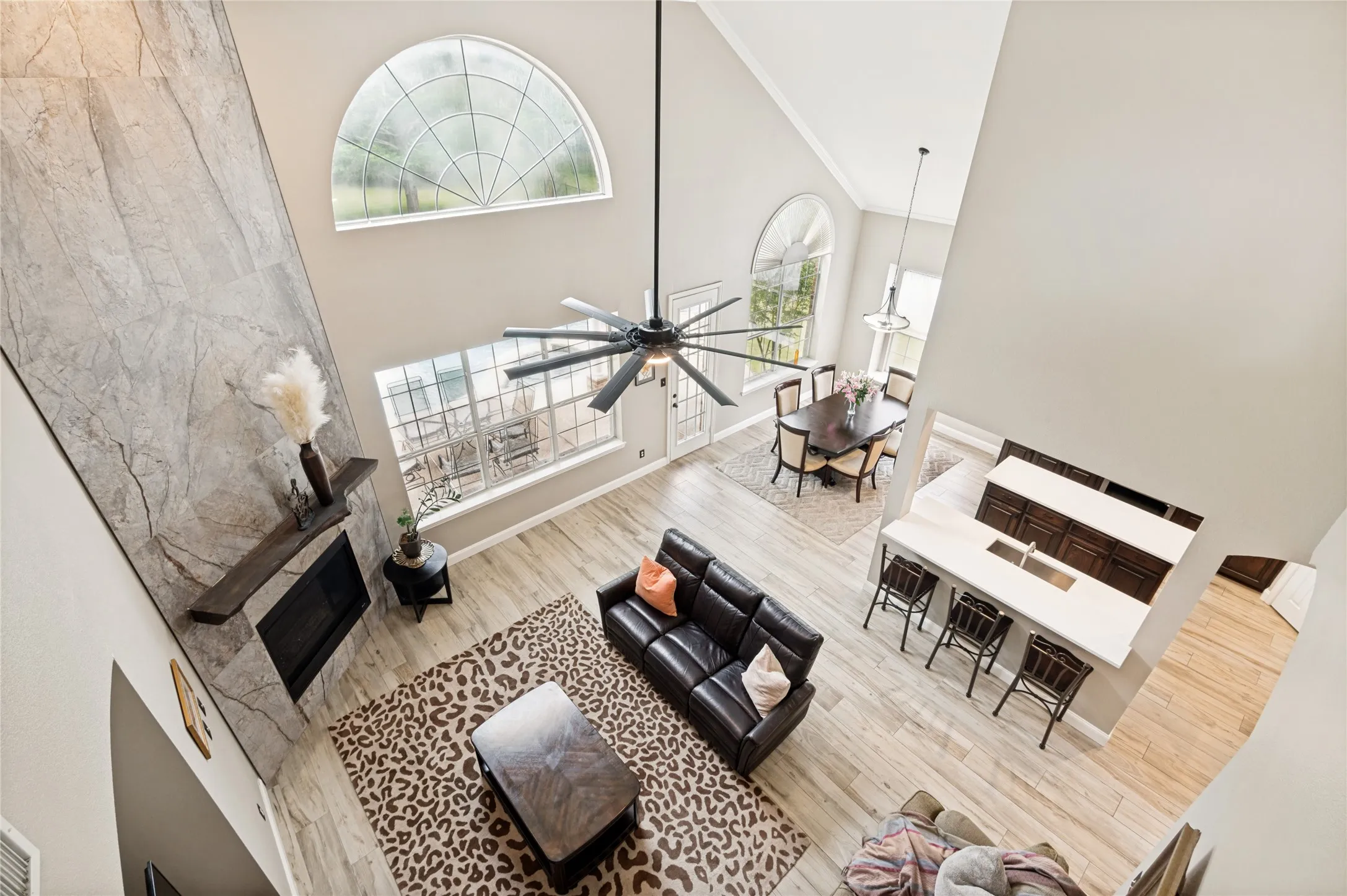 Soaring vaulted ceilings above a living area featuring a floor-to-ceiling stone-finish fireplace