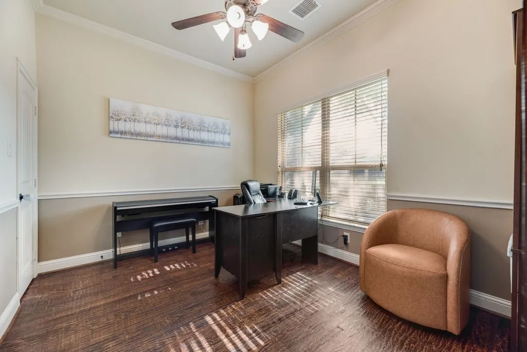 Flex room, Office, or 5th bedroom featuring wood-finish flooring, a ceiling fan with light fixture, and crown molding