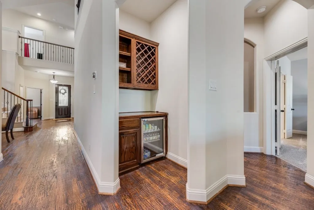 Integrated beverage station with wine rack cabinetry and built-in cooler