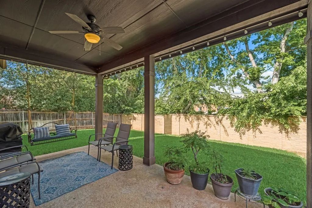 Covered patio with a ceiling fan, concrete flooring, and recessed lighting