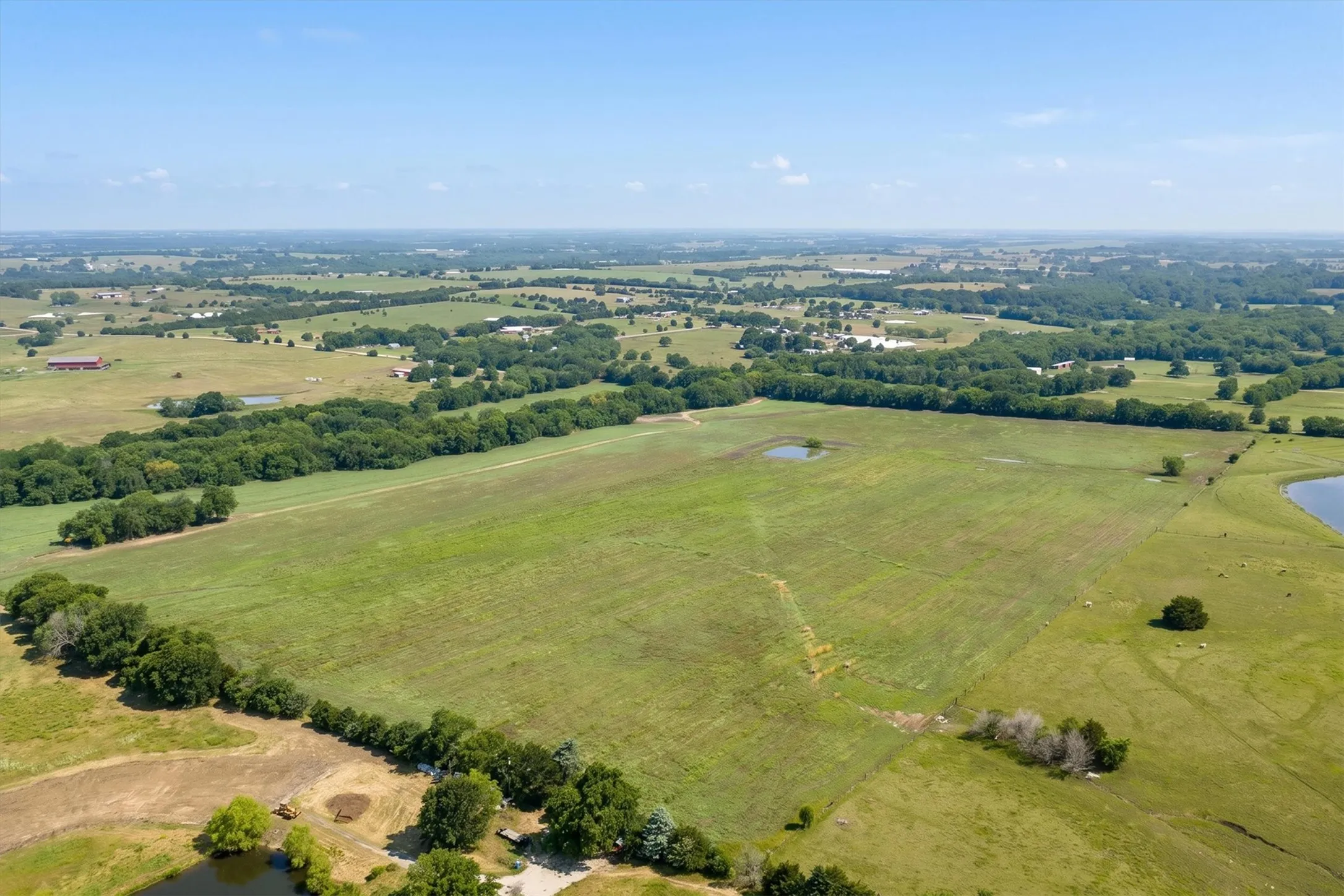 Expansive agricultural land featuring a large, cultivated field