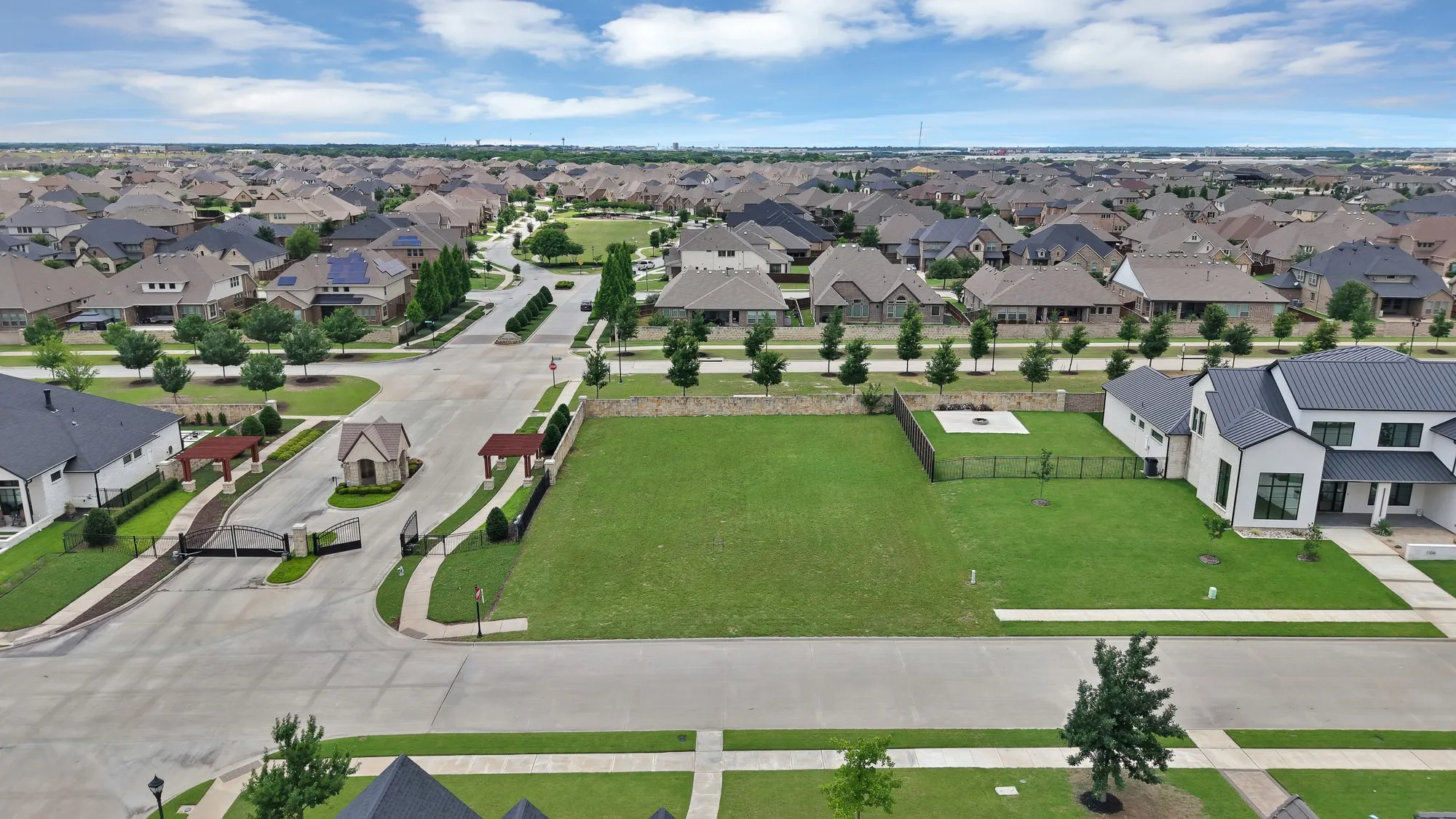Lot aerial with neighborhood overview — Nearly half-acre interior lot situated directly adjacent to the South Pointe gated entry. Lot is cleared, level, and fully sodded. Surrounded by established custom homes with mature tree-lined streets throughout.