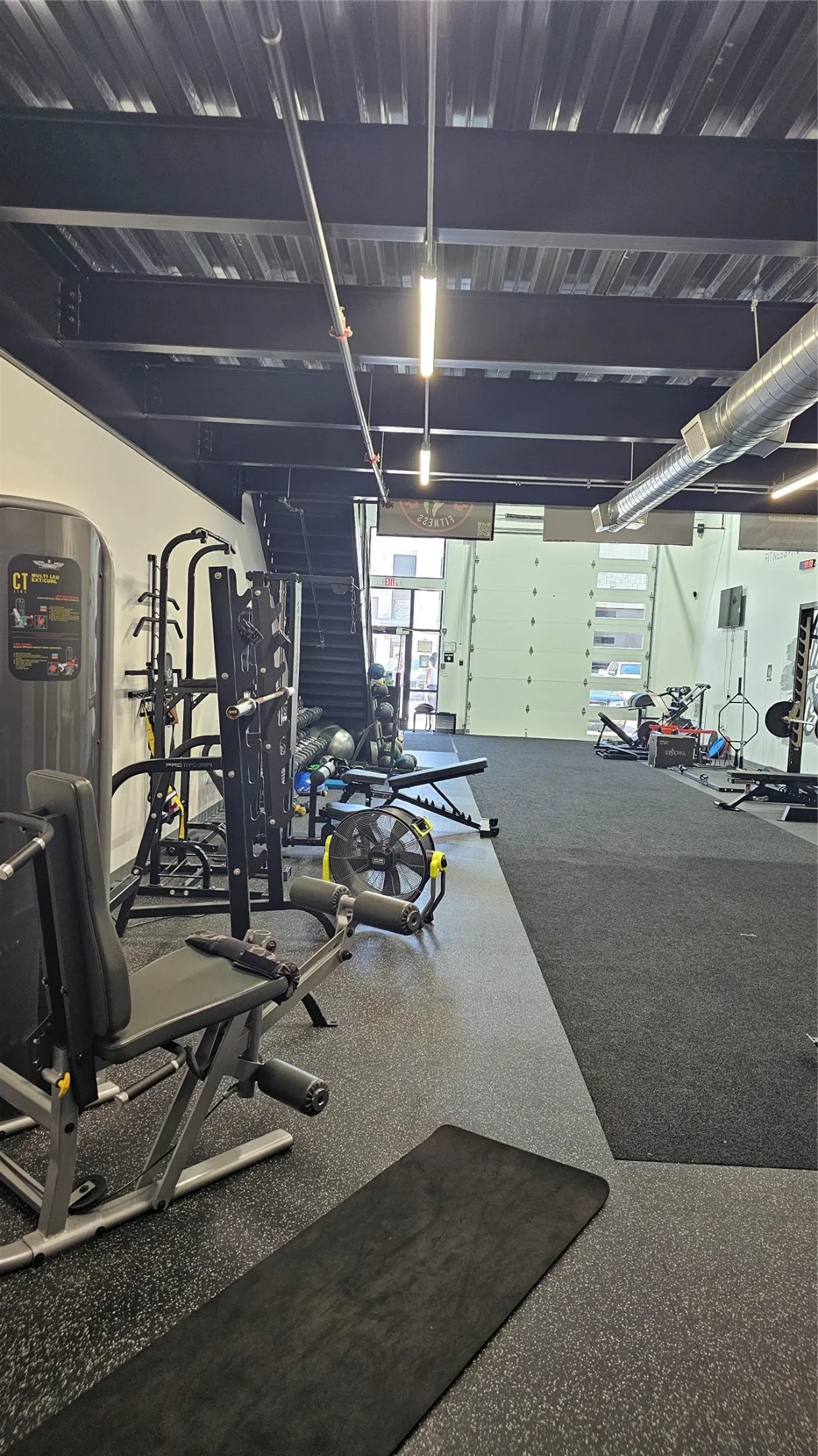 Spacious interior featuring exposed ductwork and structural beams