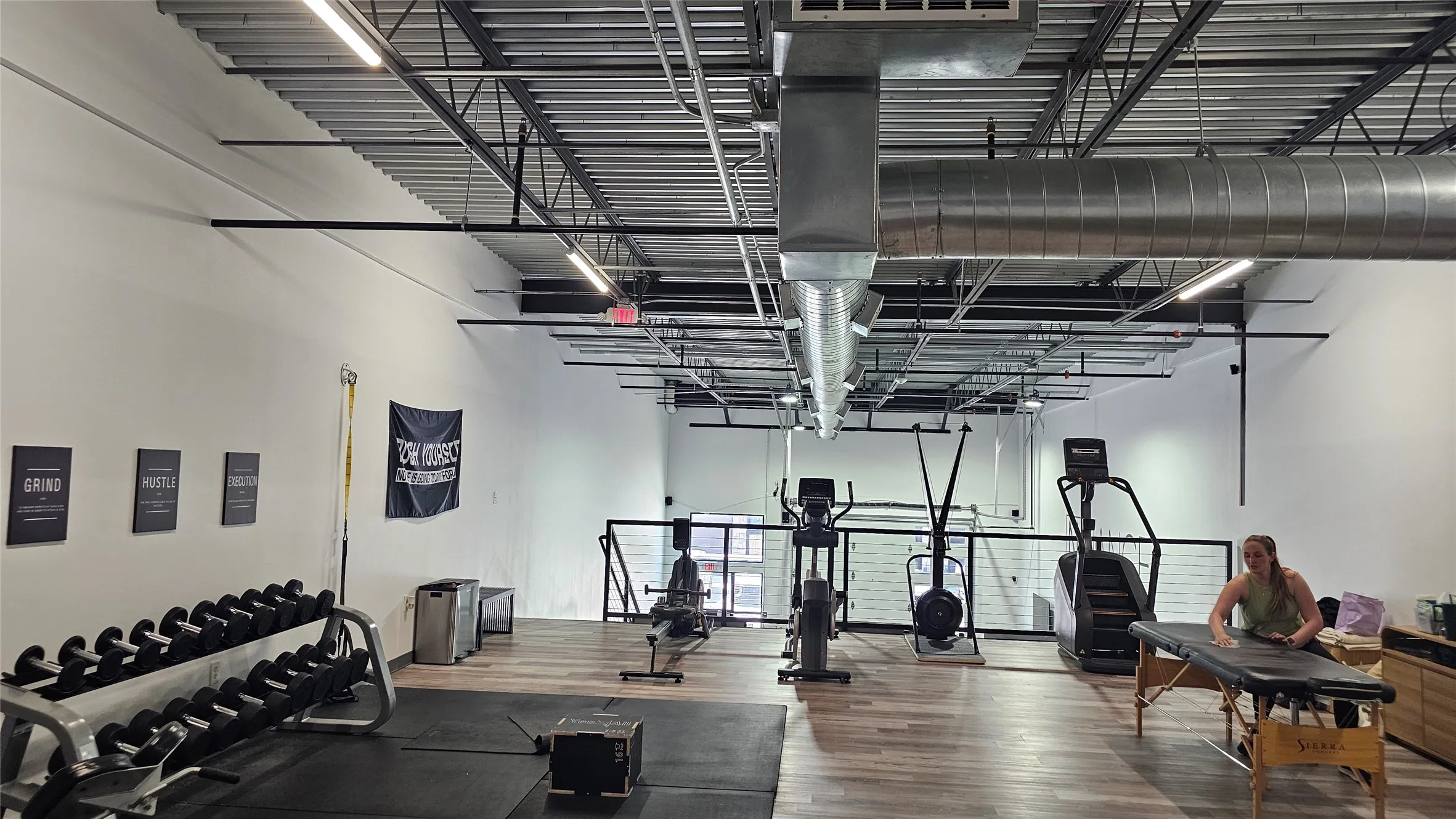 Spacious interior with high exposed ceilings and industrial-style ductwork
