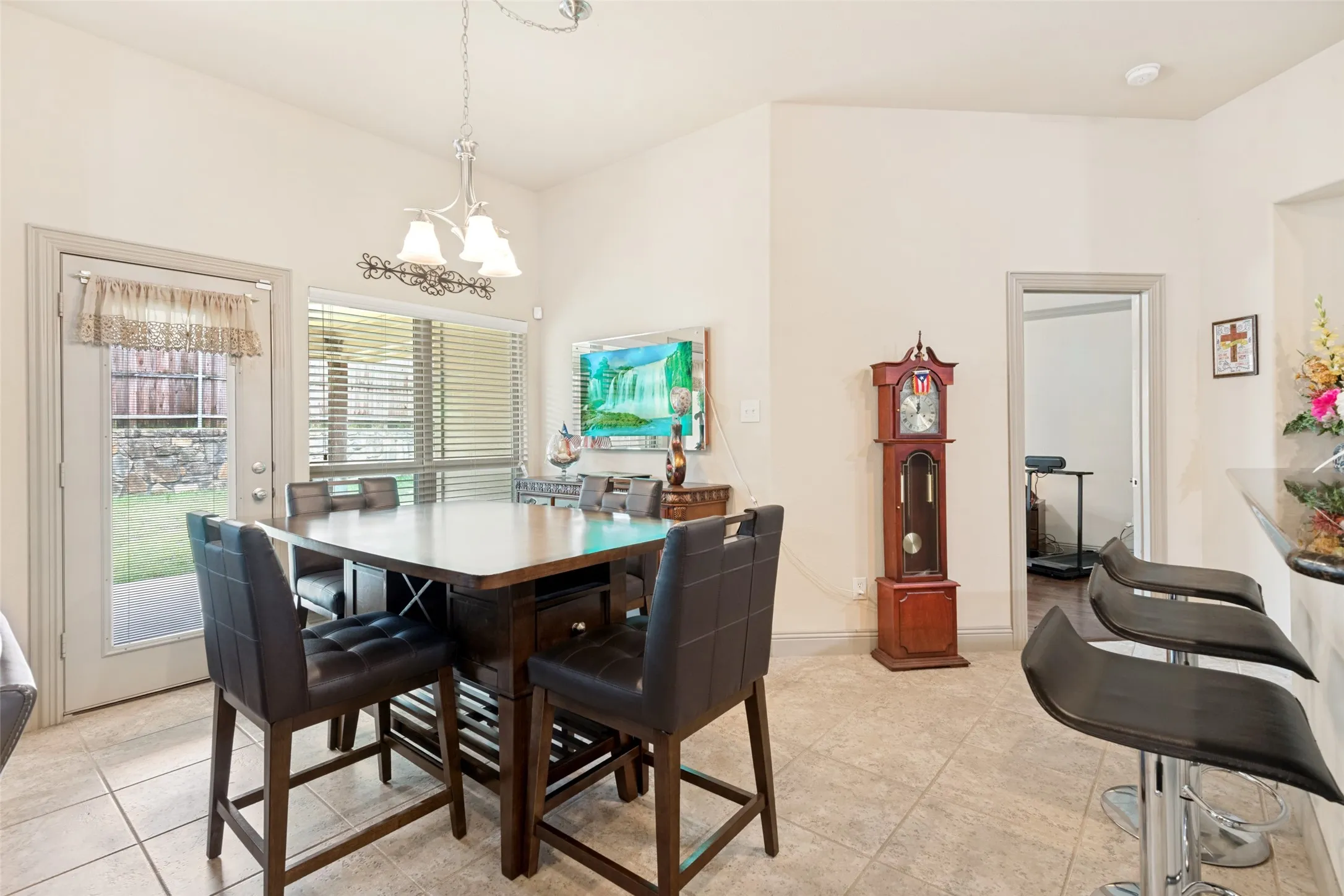  Breakfast seating at the bar, room for large table, streaming light thru windows and door leading out to nice size covered patio.