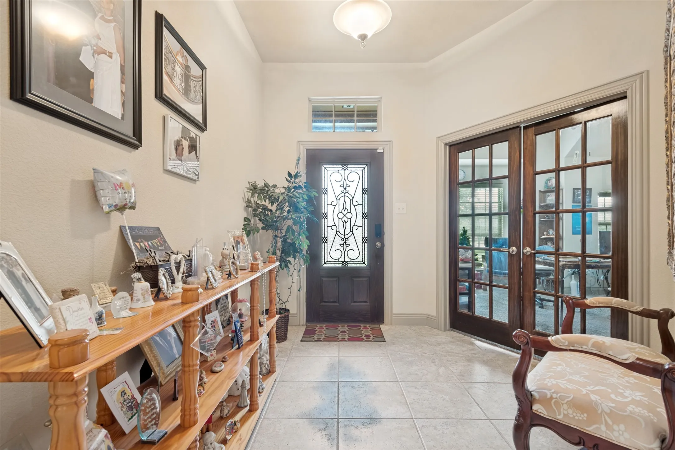 Beautiful Tiled flooring in Foyer French Doors to Office.