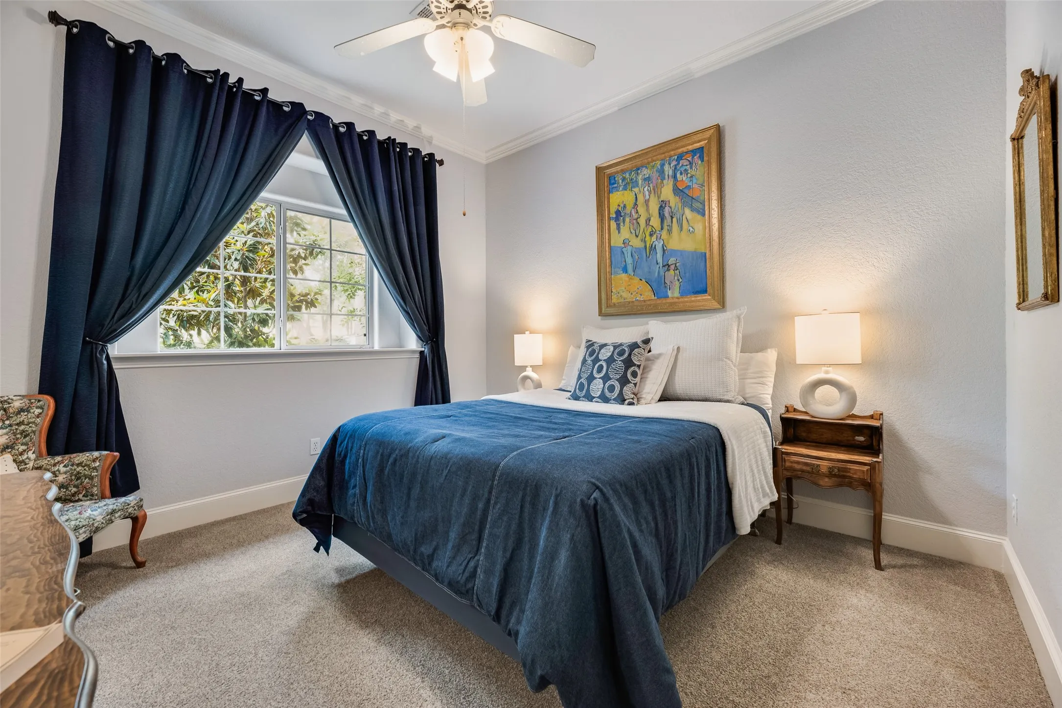 Wall-to-wall carpeting and neutral wall tones define this bedroom space