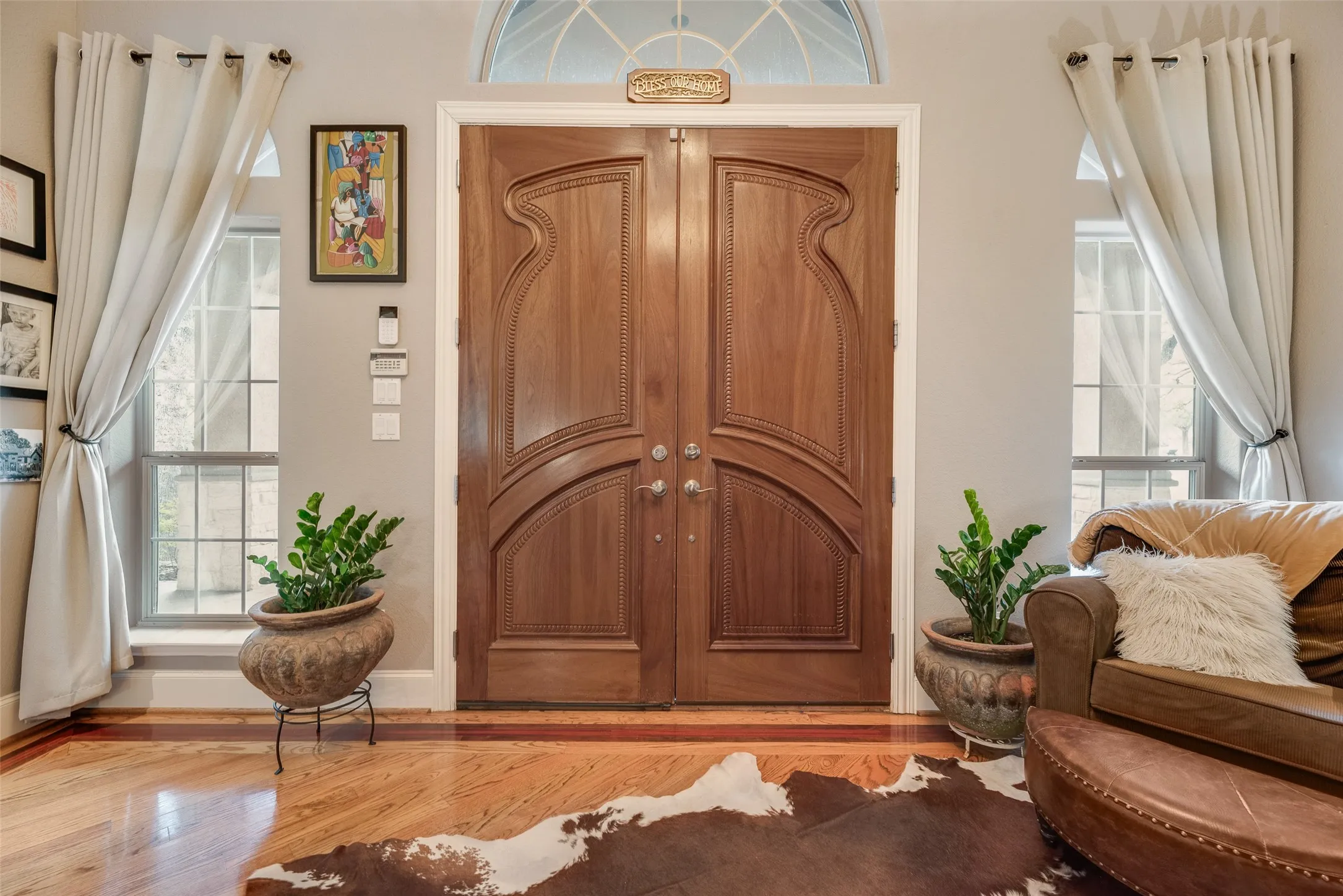 Ornate double wooden entry doors with distinctive carved paneling
