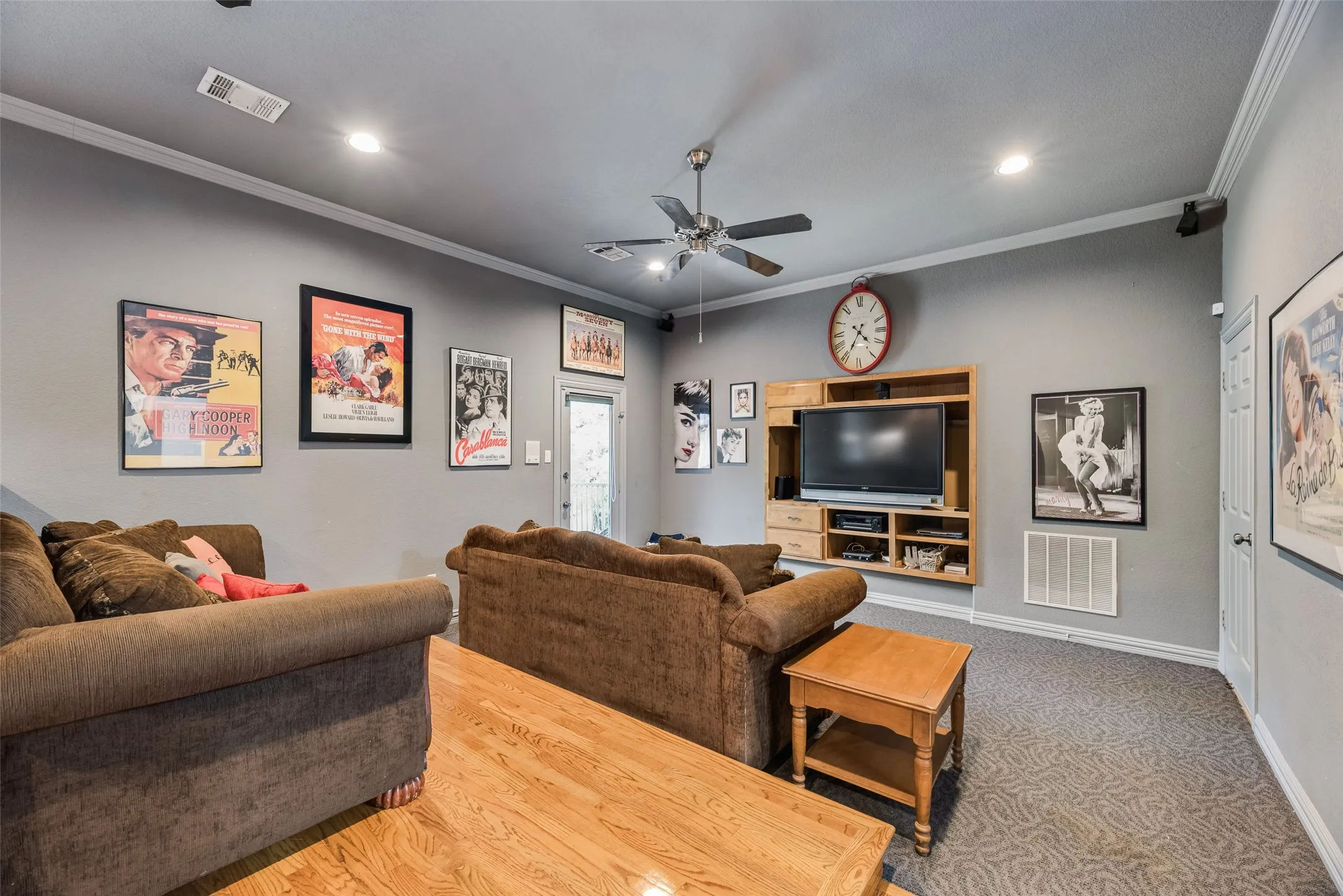 Spacious room featuring a partial wood-finish floor and partial patterned carpet