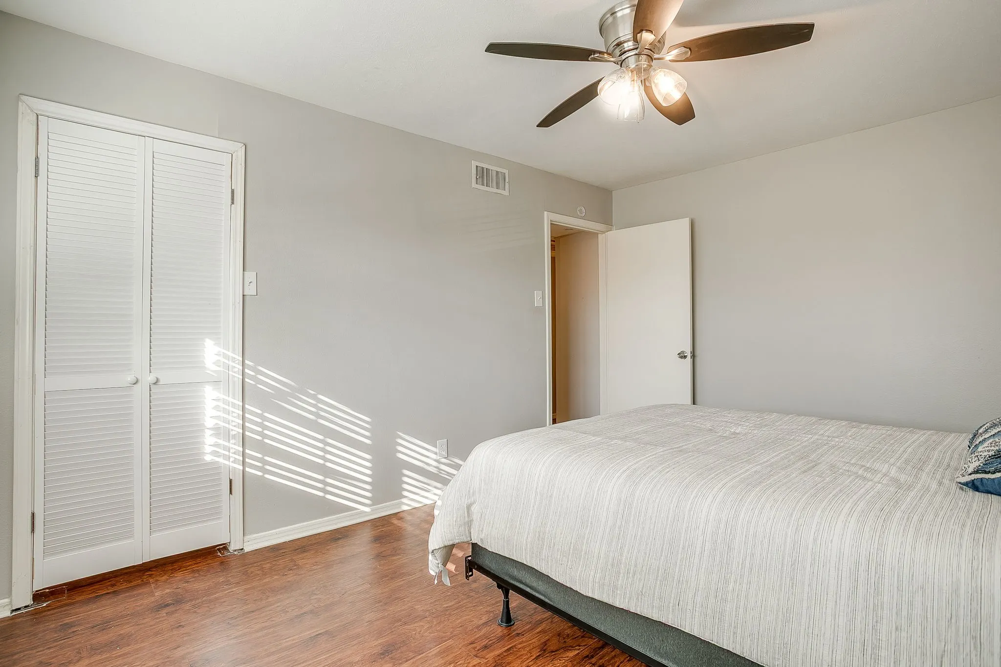 Wood-finish flooring throughout, complemented by light gray wall tones and white baseboards