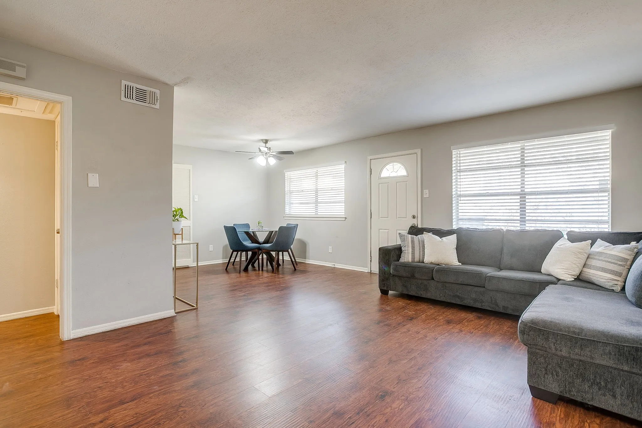 Open-concept living area featuring wood-finish flooring throughout