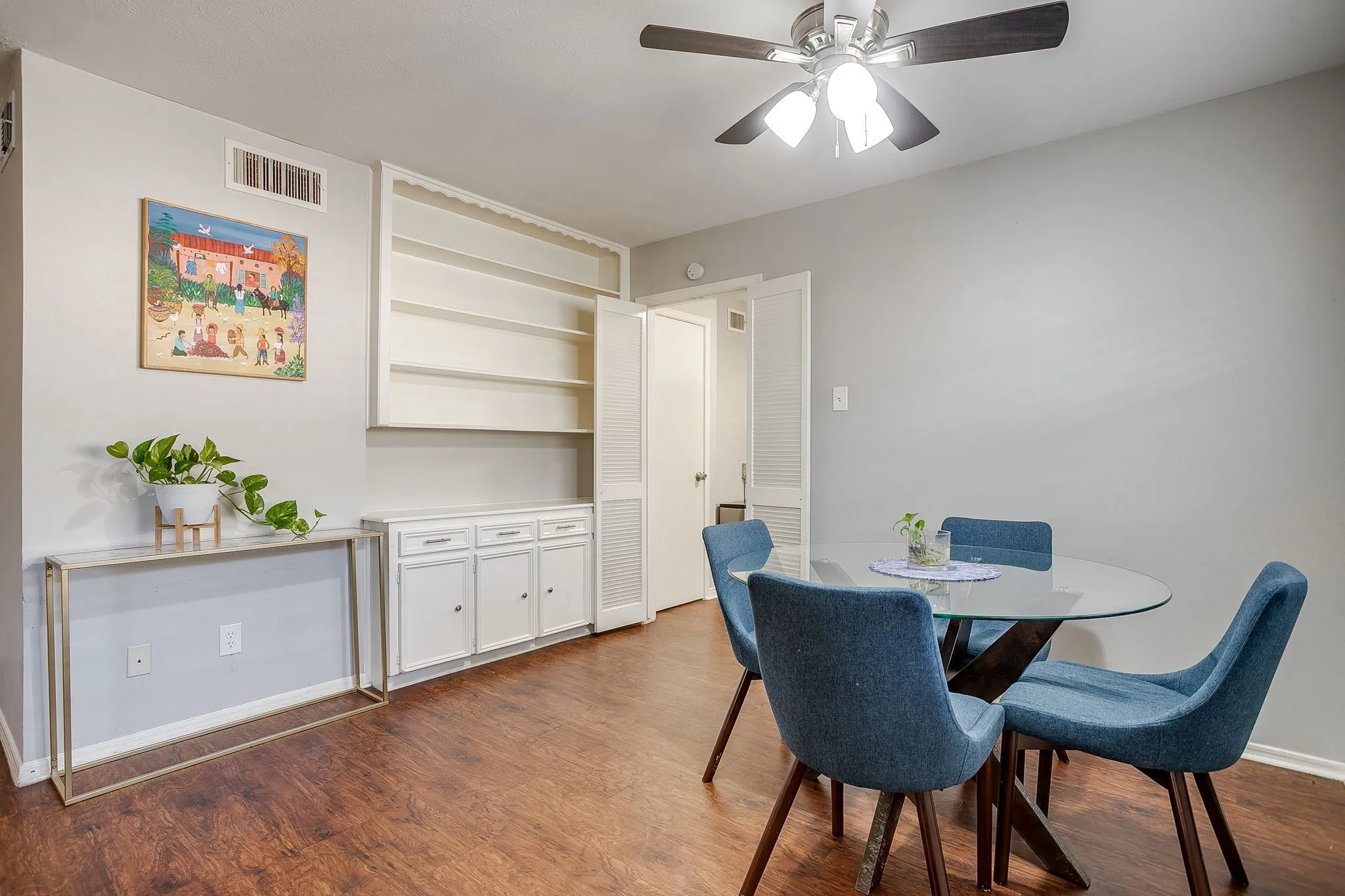 Open concept dining area featuring wood-finish flooring and light gray walls