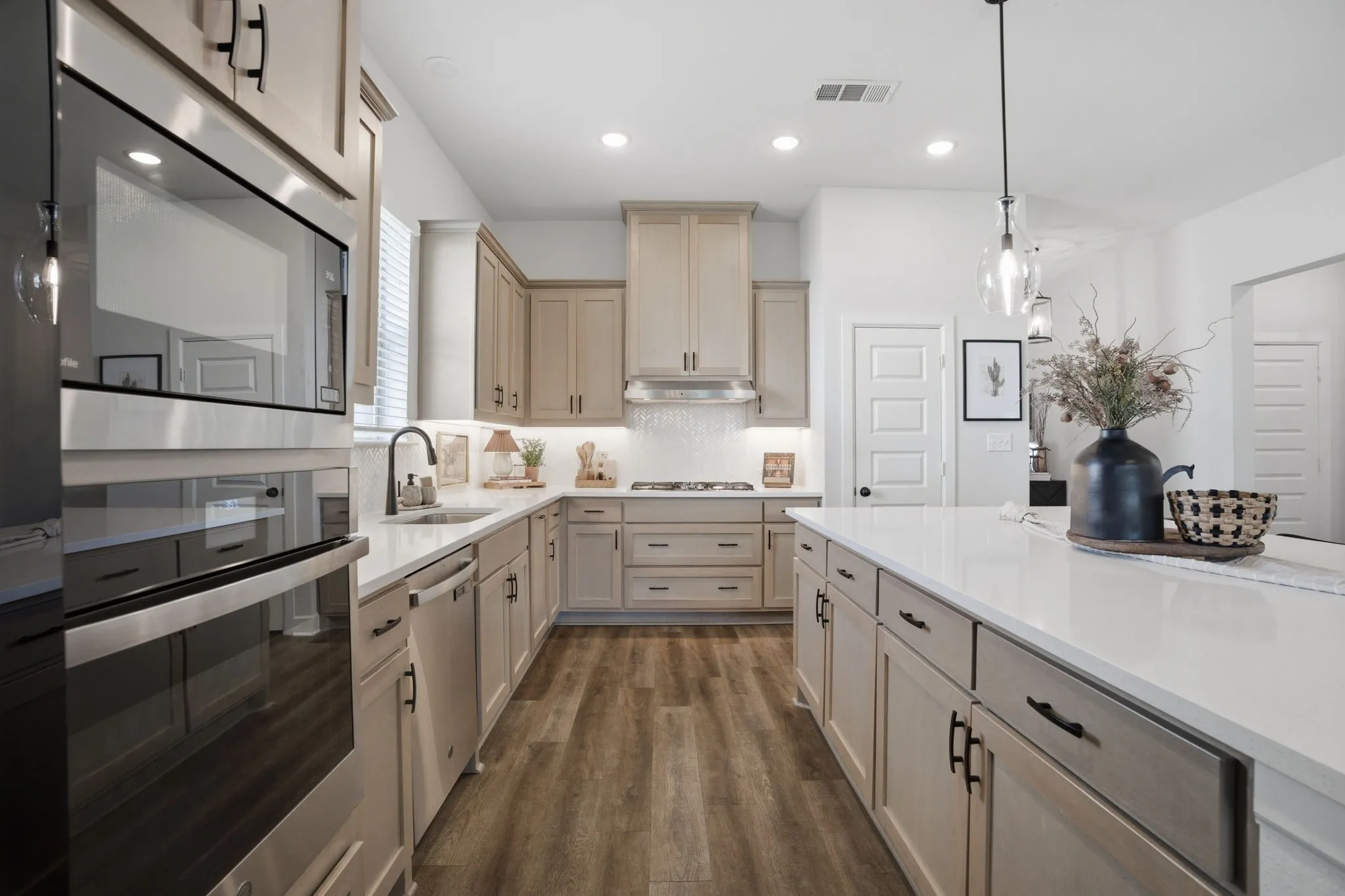 This stunning gourmet kitchen features beautifully crafted, light-toned cabinetry, creating a bright and inviting space that is perfectly designed to inspire and accommodate even the most passionate and skilled chef.
