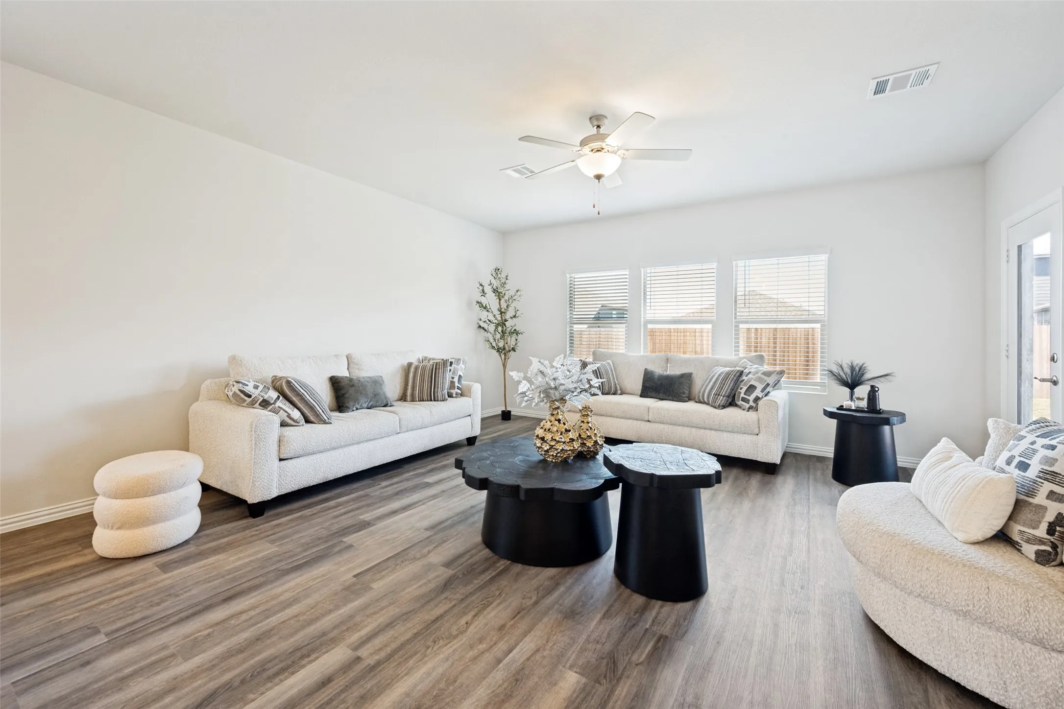 Spacious interior with neutral white walls and wood-finish flooring