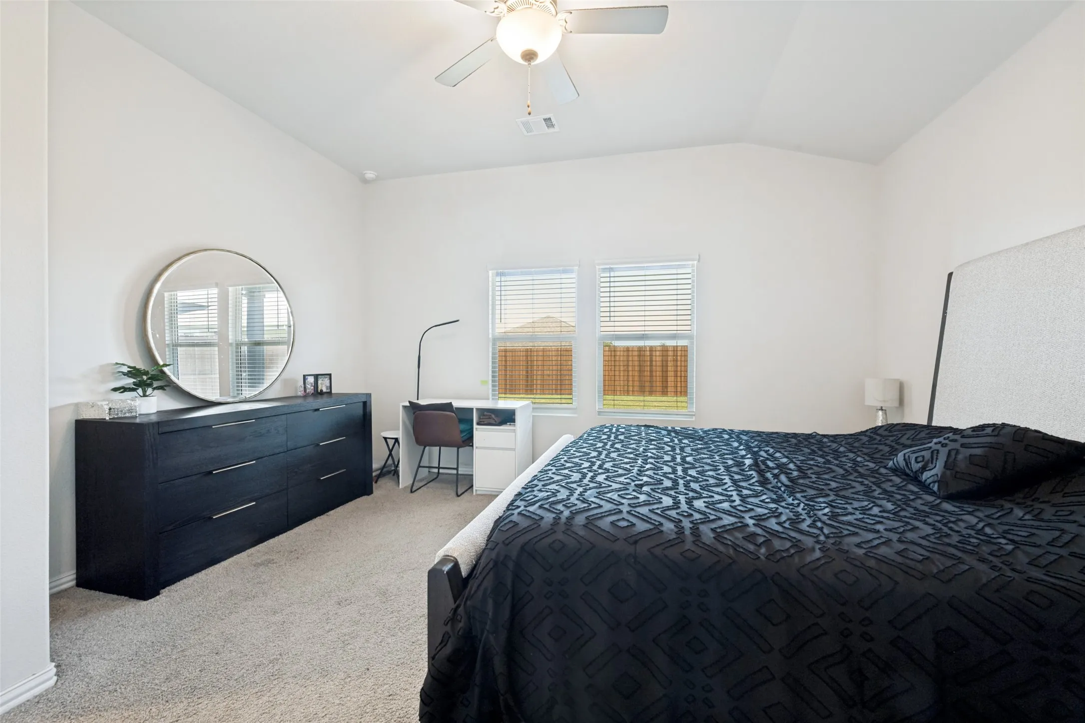 Bedroom featuring vaulted ceilings and neutral carpeting