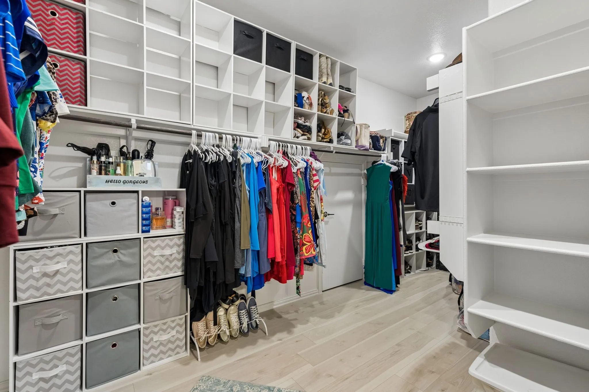 Primary Custom closet system featuring extensive shelving, hanging rods, and built-in cubbies