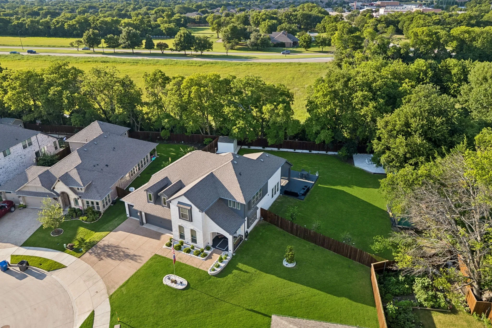 Contemporary residence featuring a two-story elevation, a dark gray shingle roof, and a two-car garage