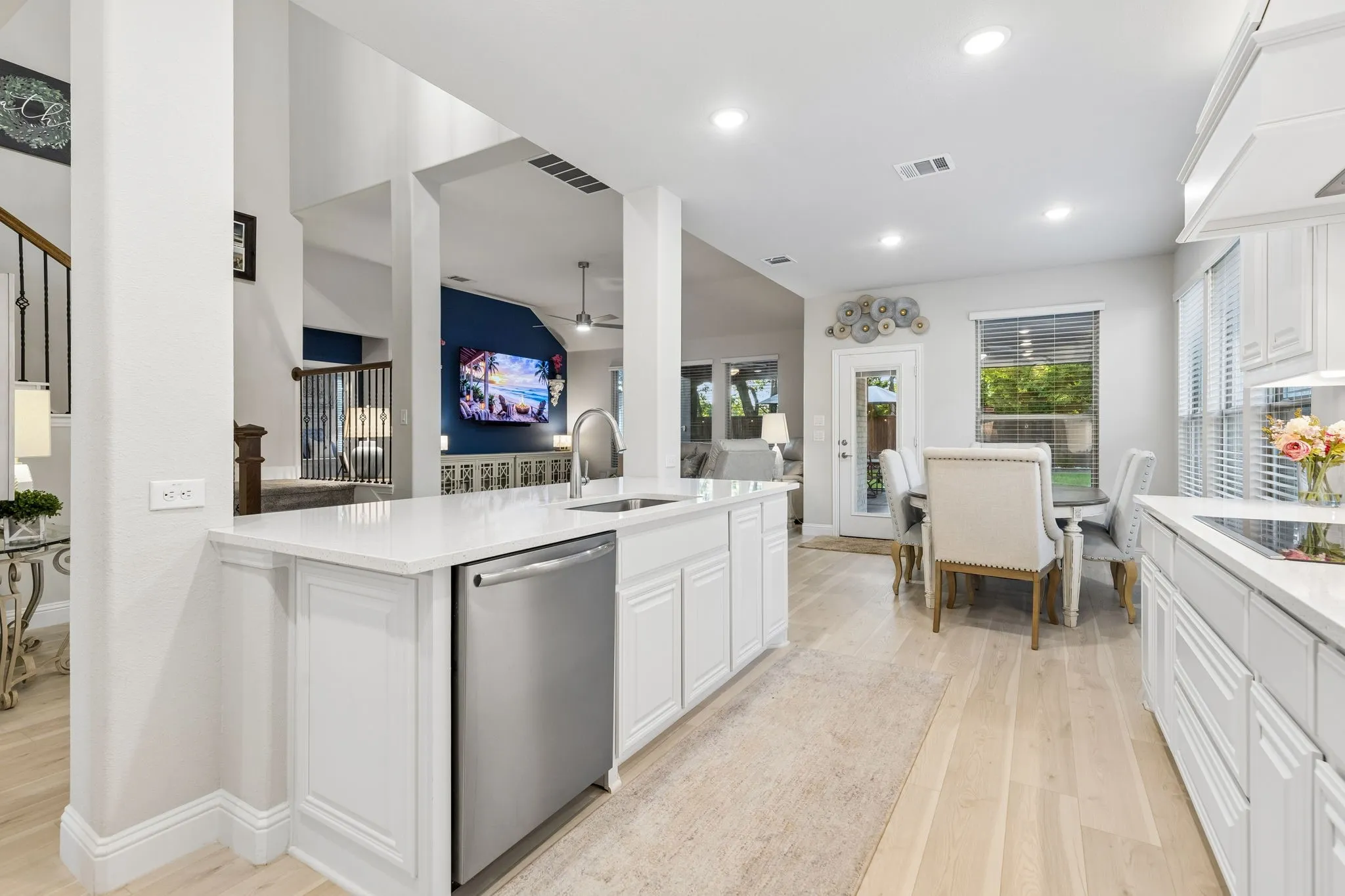 Open-concept kitchen featuring an expansive island with white cabinetry, a stainless steel appliances.  Beautiful entertaining space.