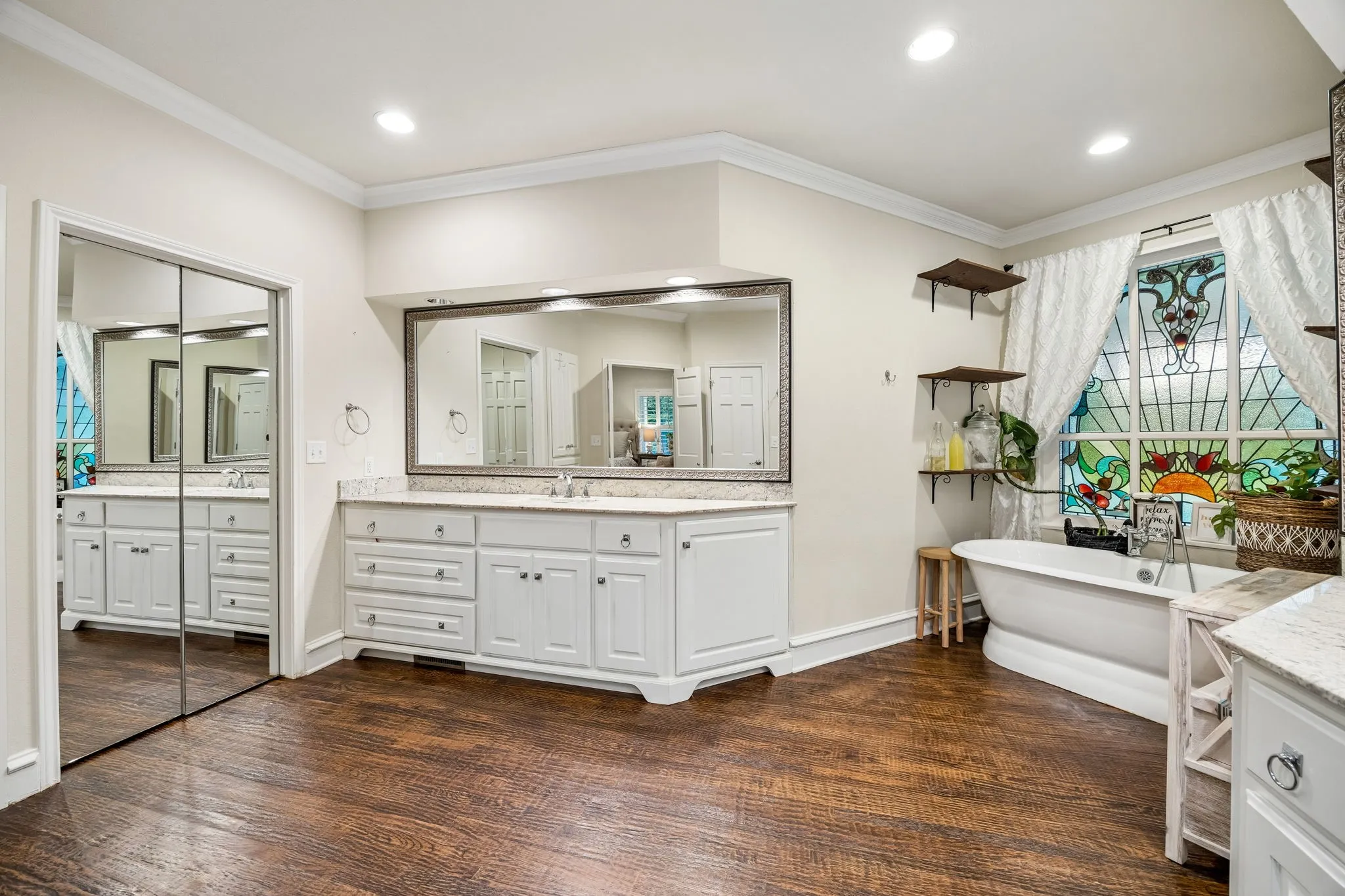 Another view of the large primary bath with walk-in closet on the left