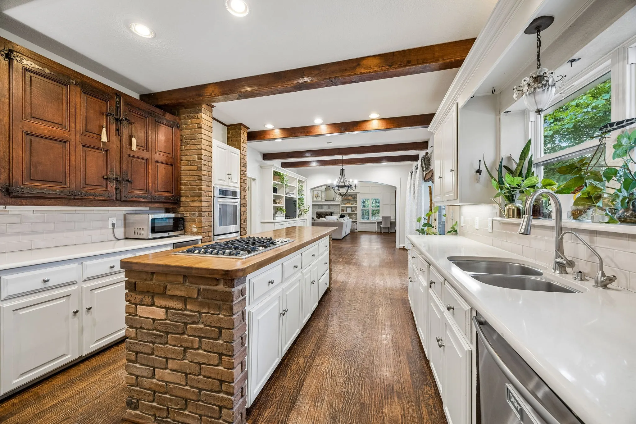 Beautiful Custom period cabinetry and a gas cooktop complement the kitchen