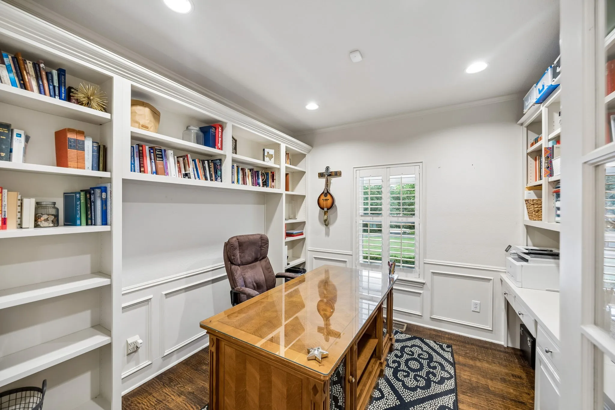 First floor office with with custom built-ins and recessed lighting.