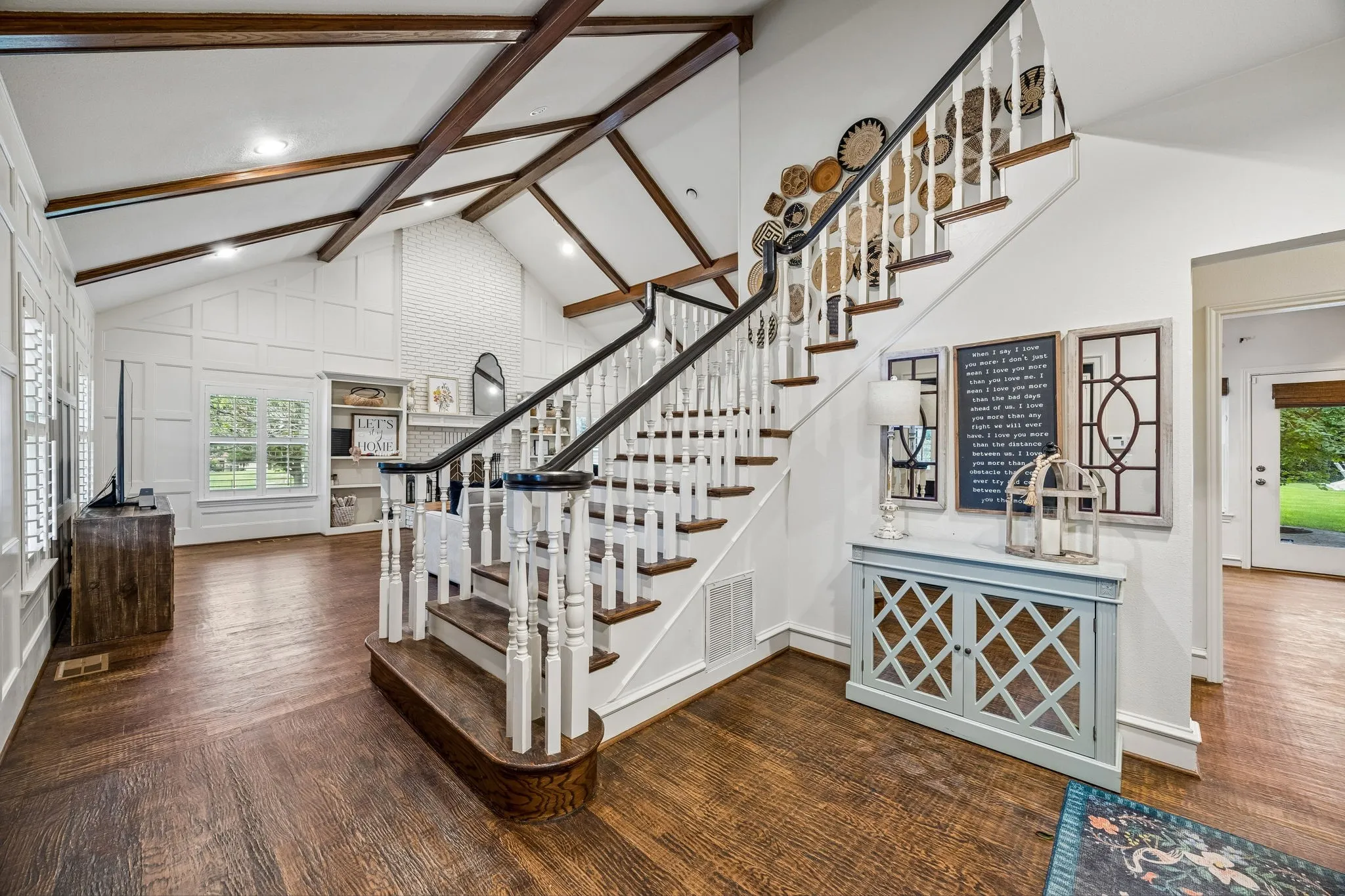 Welcoming entry with first floor living area to the left and kitchen and dining to the right.
