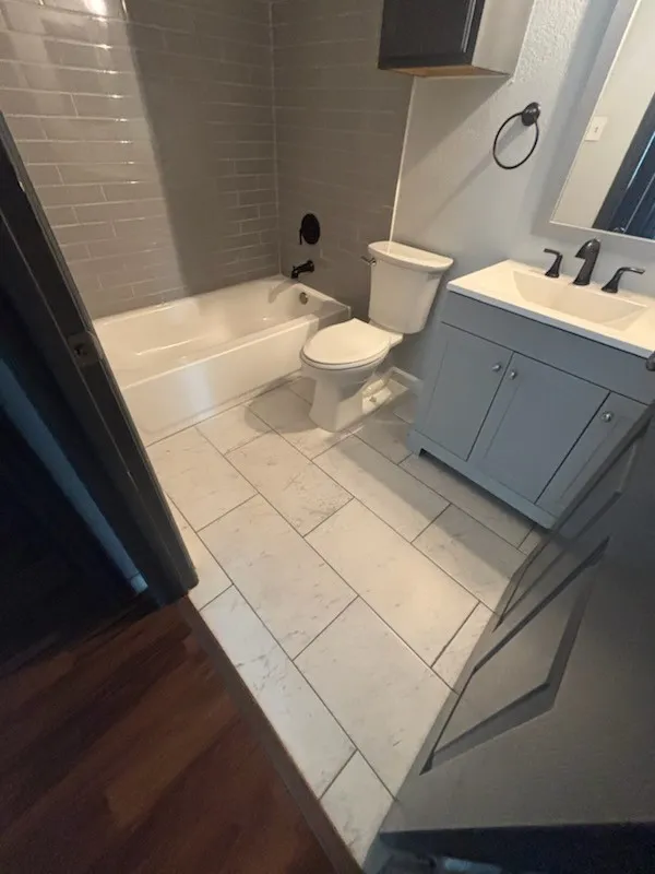 Bathroom featuring light gray subway tile shower surround and a white​​‌​​​​‌​​‌‌​‌‌​​​‌‌​‌​‌​‌​​​‌​​ bathtub