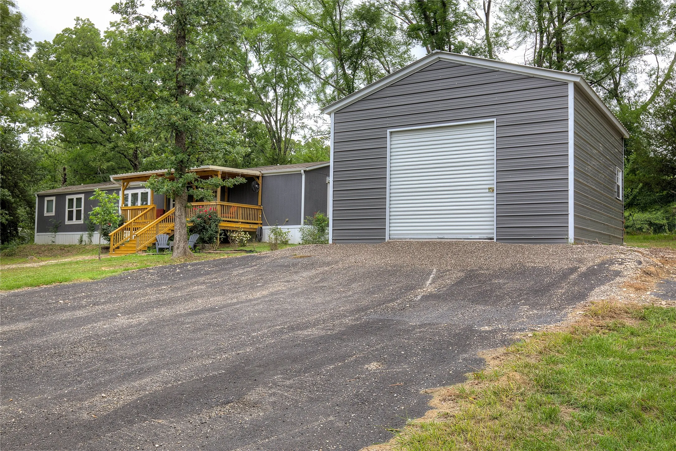 Separate metal garage /workshop has roll up door plus side door.
