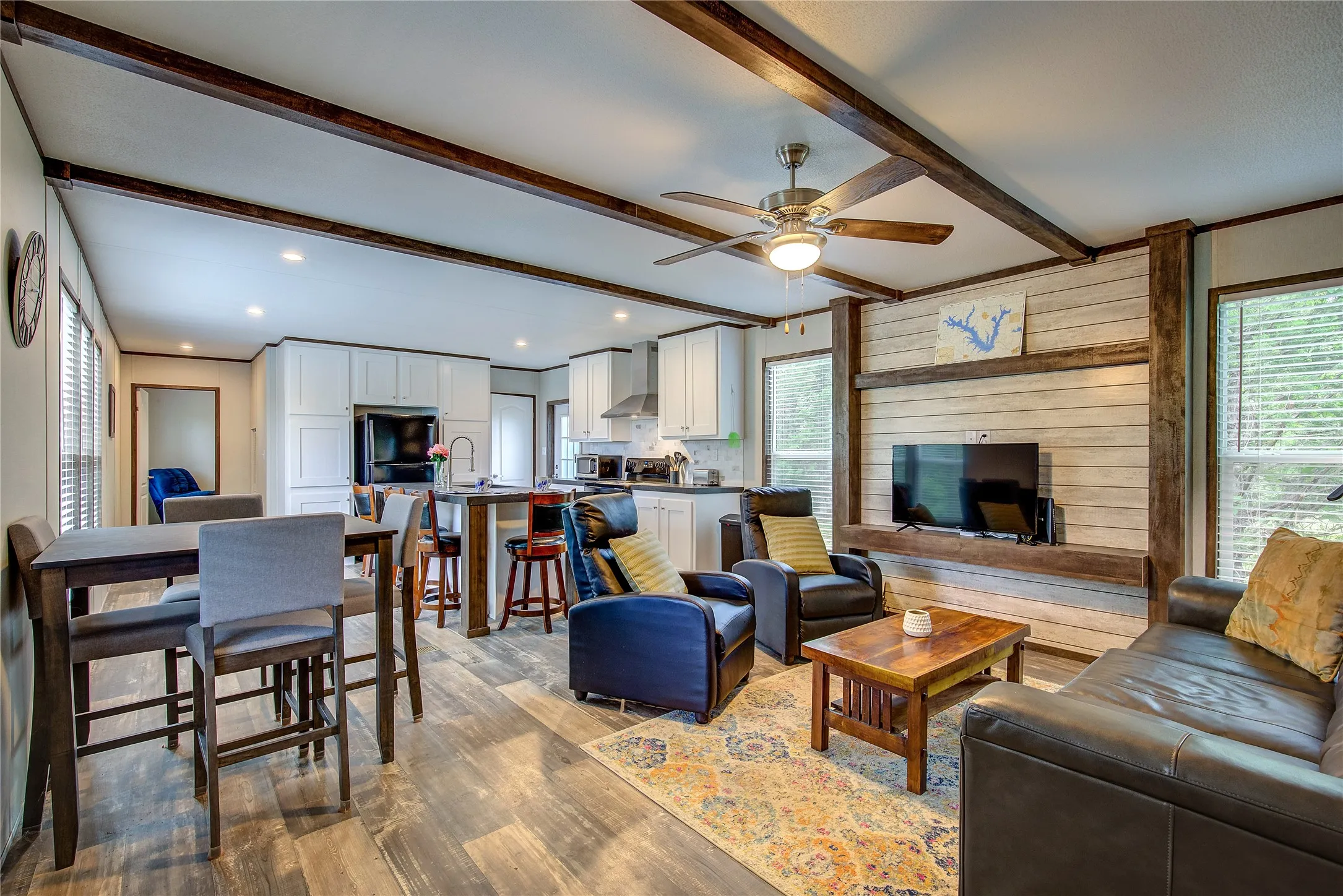 Living area has space for dining table, cool wood accent wall