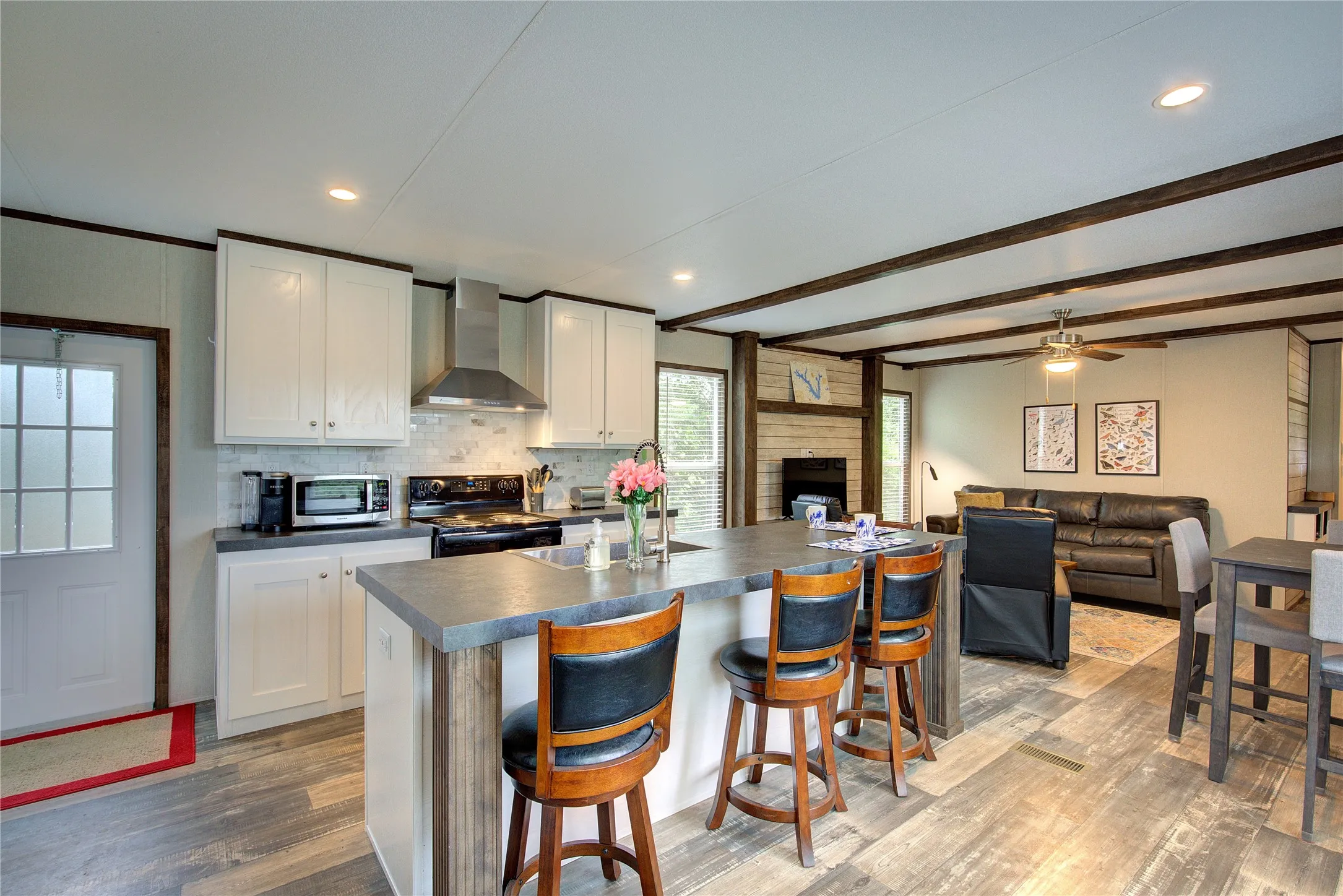 Kitchen has back door, lots of seating space