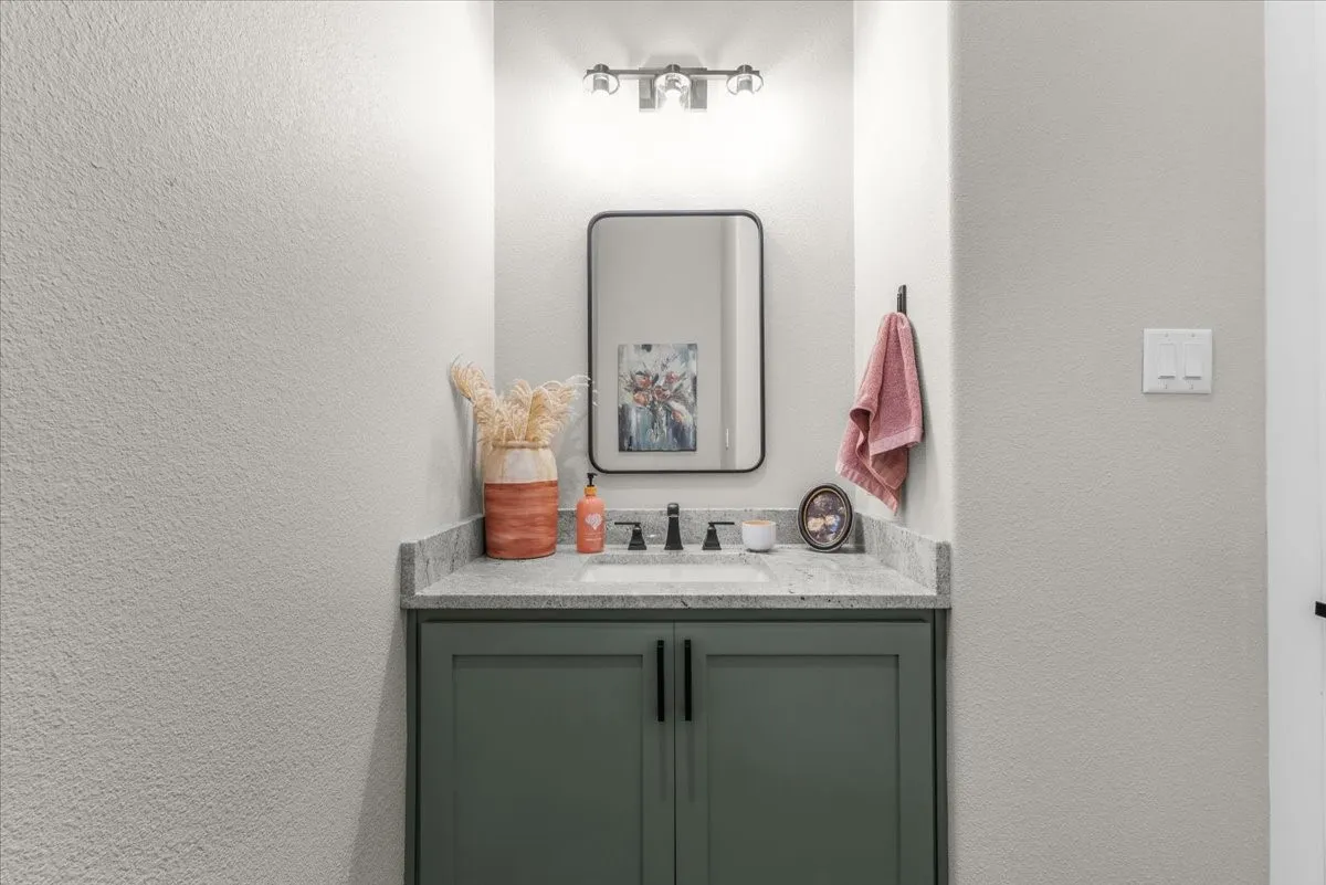 Half Bathroom vanity featuring a granite countertop