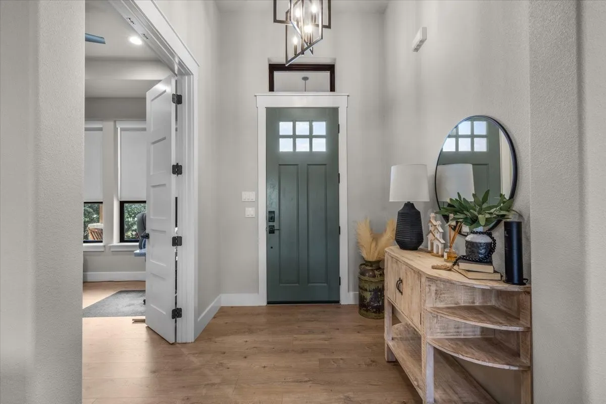 Entryway featuring a paneled wood door and decorative lighting