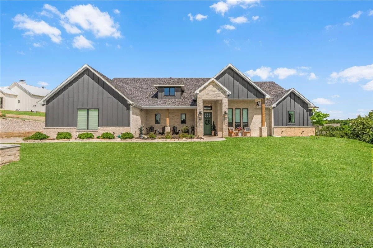 Front of home with stone and vertical board-and-batten siding