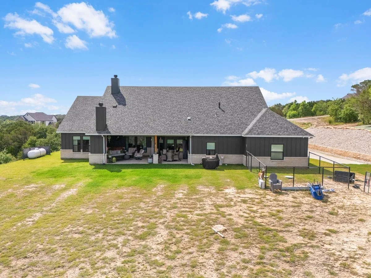 Back of property featuring small, fenced area or dog run.