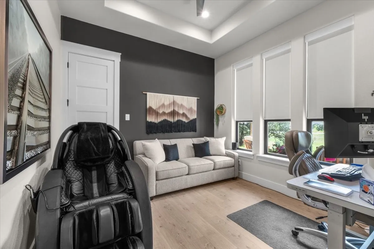 Flex room- can be a 5th bedroom with a closet or office featuring a tray ceiling, accent wall and three windows with roller shades