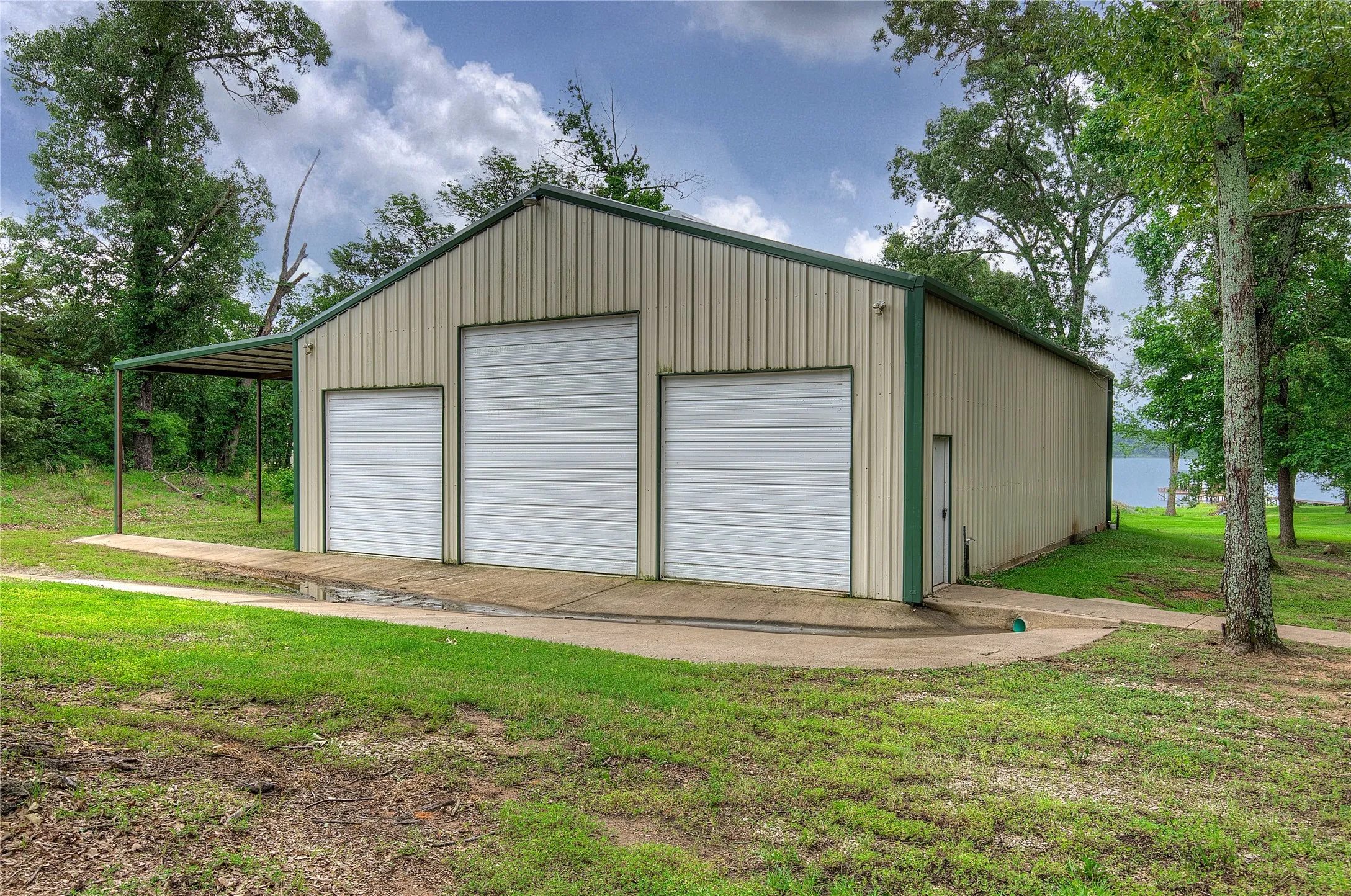 Steps from the house is this DREAM of a workshop; three roll-up doors in front, one in back, equipment overhang, plus two entry doors.
