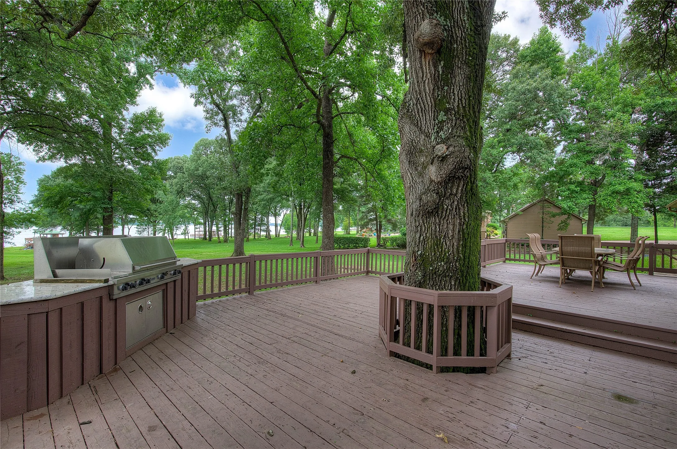 Deck has mature oak shade tree, built-in grill, and lake views!