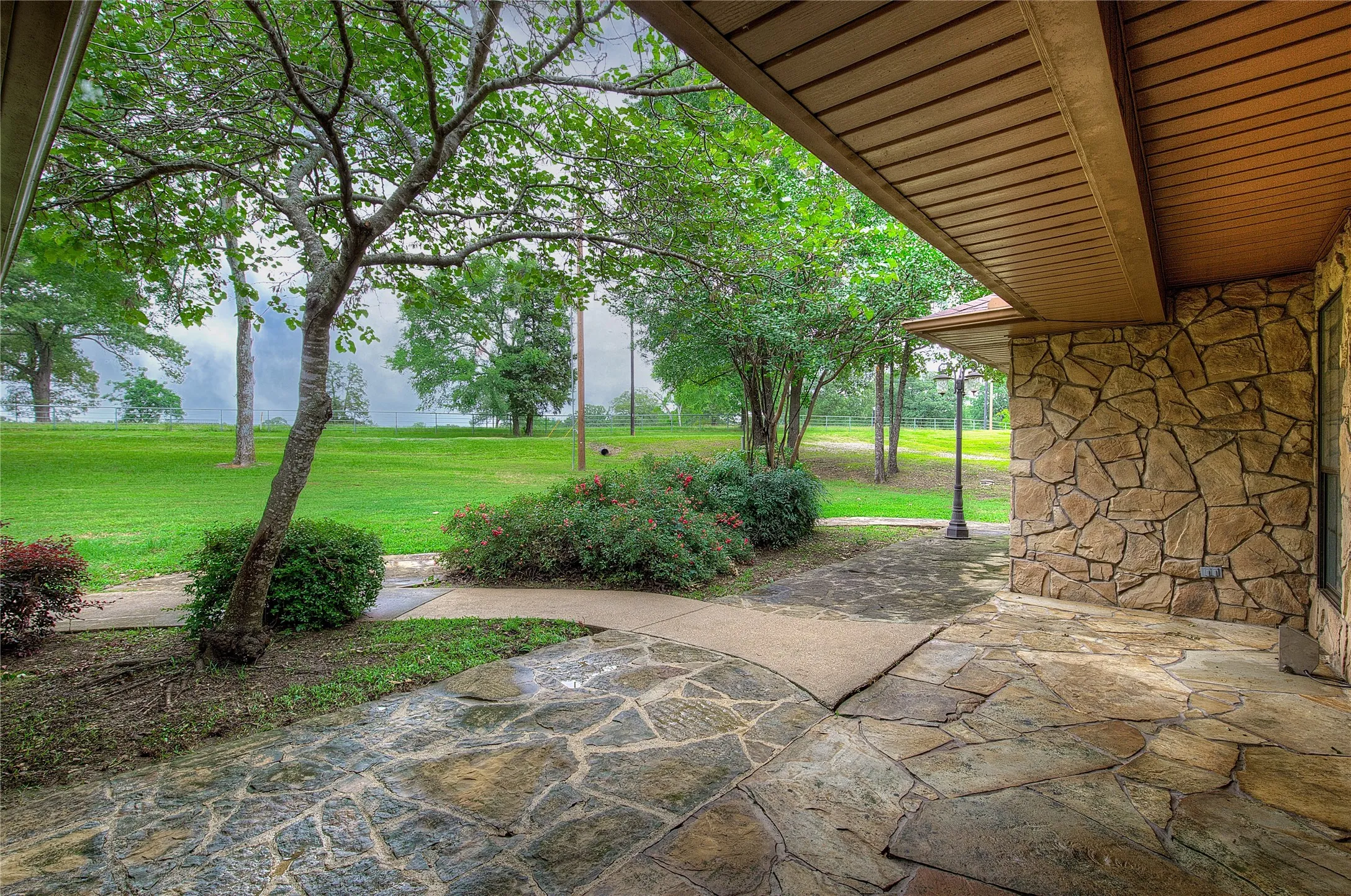 Entering the home, you'll see a flagstone covered front porch and lush landscaping.