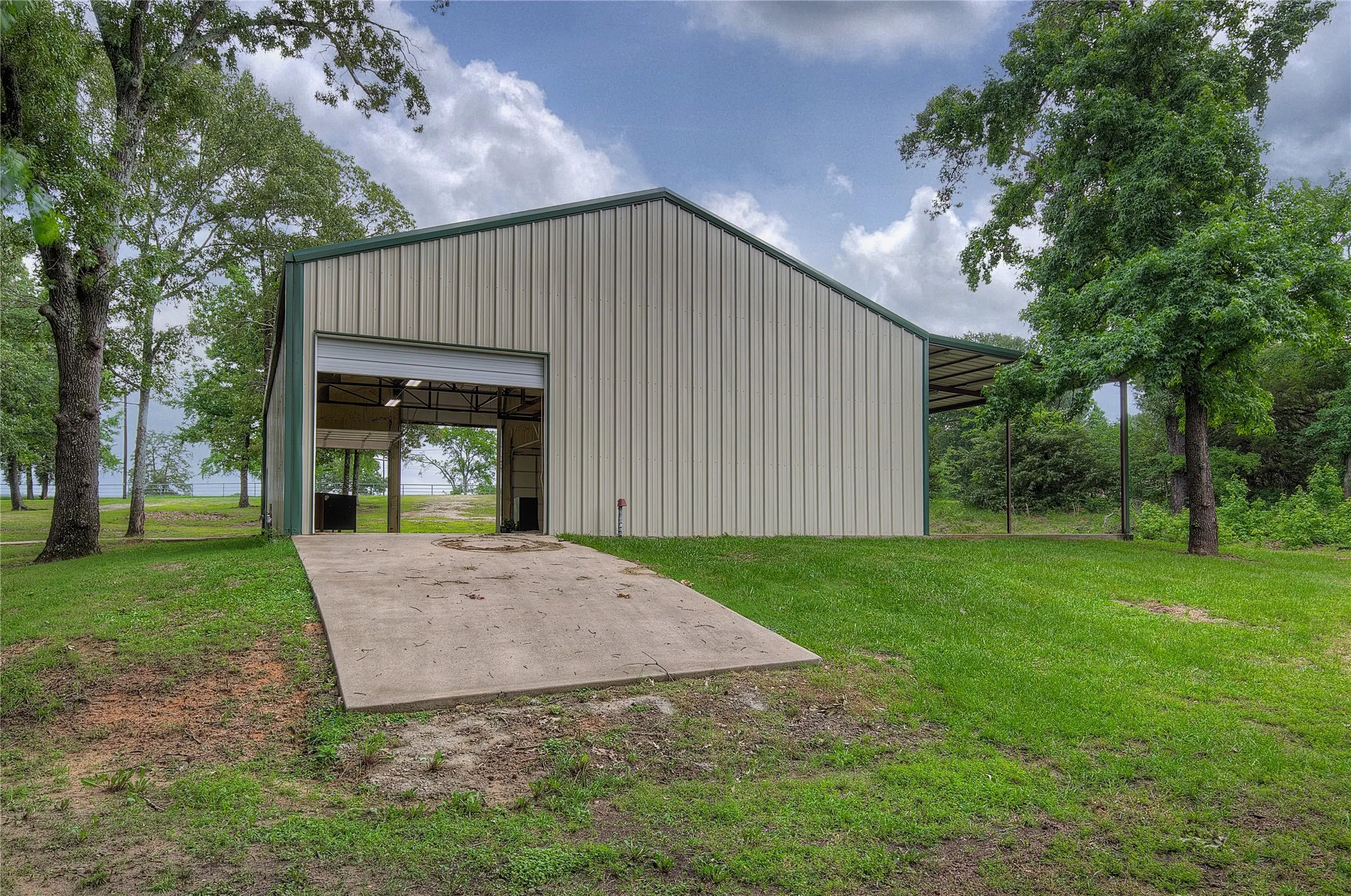 Back of workshop has roll-up door and concrete ramp for easy access to the boat dock