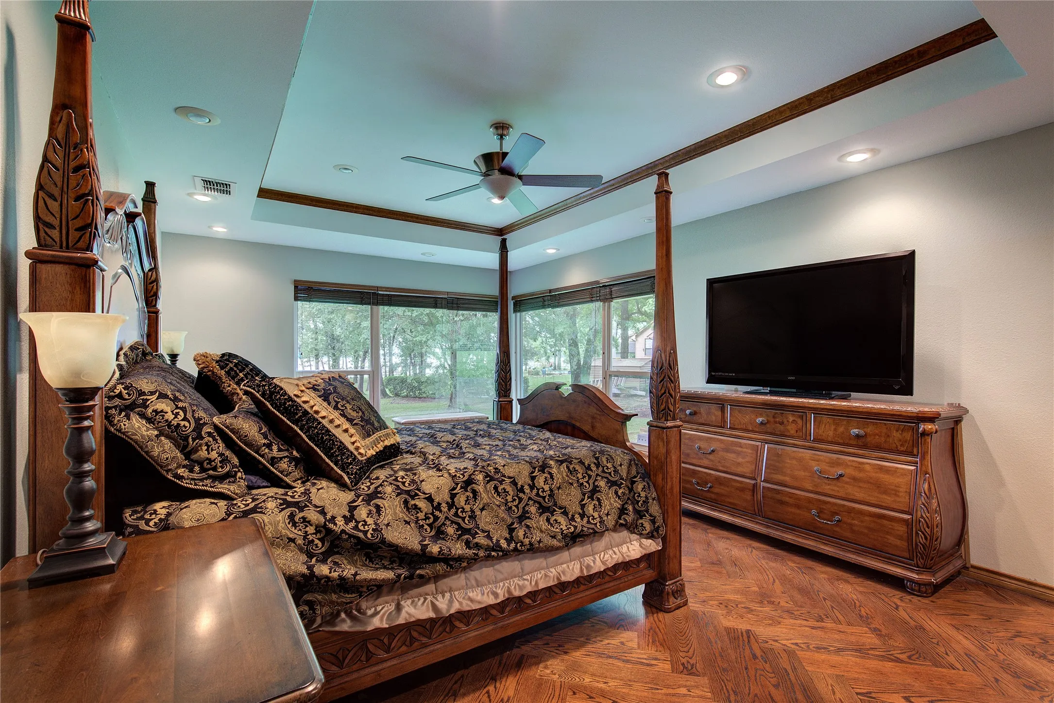 The guest wing has 3 bedrooms; this one is very large, with a trey ceiling, wood floors, corner windows, and two closets.
