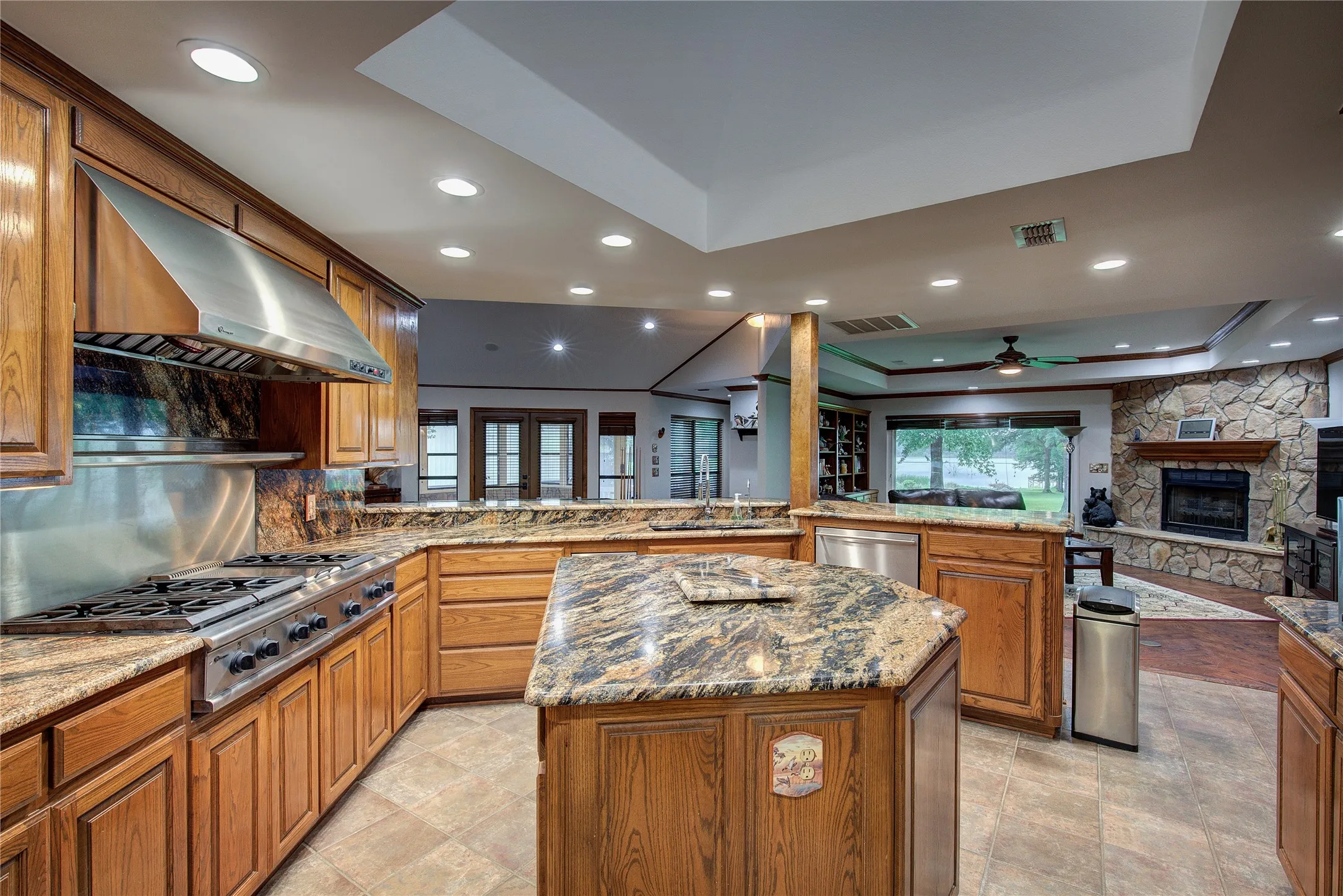 6-burner gas range with griddle and vent hood, double sink, dishwasher and trash compactor