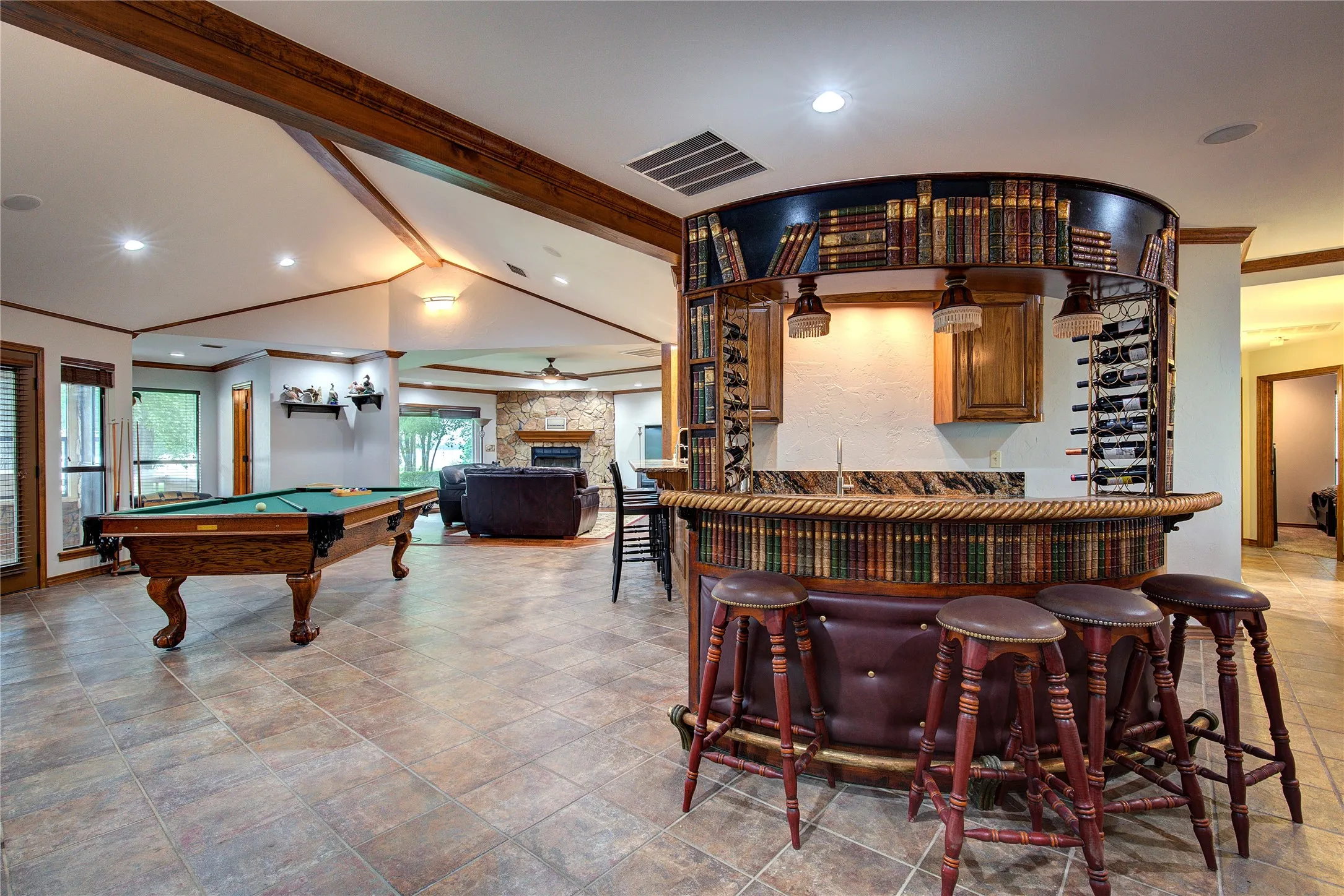 Unique feature!  Curved wet bar with wine racks, sink, wine chiller and icemaker.