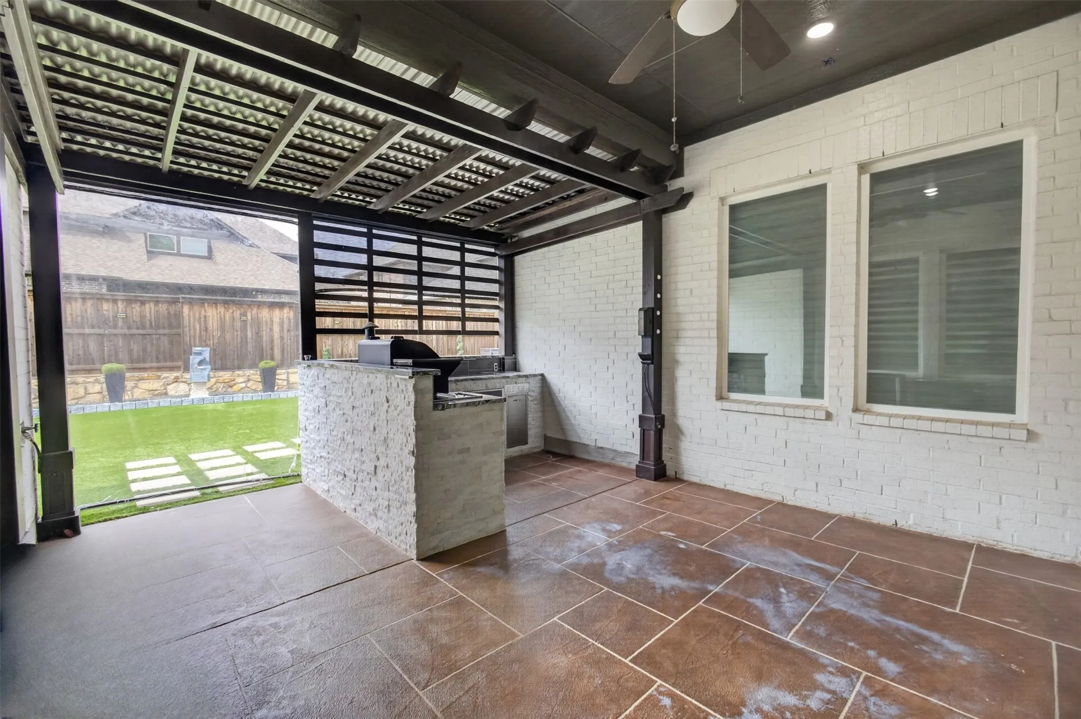 Enjoy beautiful days on the covered patio with outdoor kitchen