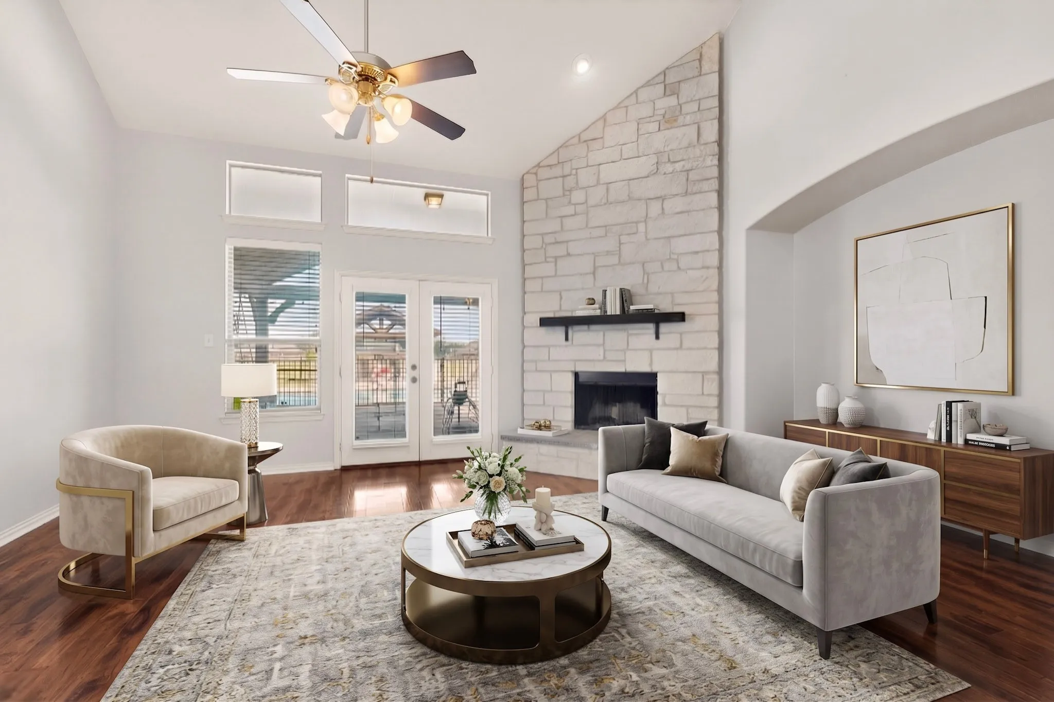 Virtually Staged. Vaulted living area featuring a stone-clad fireplace with a dark mantel, French doors, wood-finish flooring, and transom windows