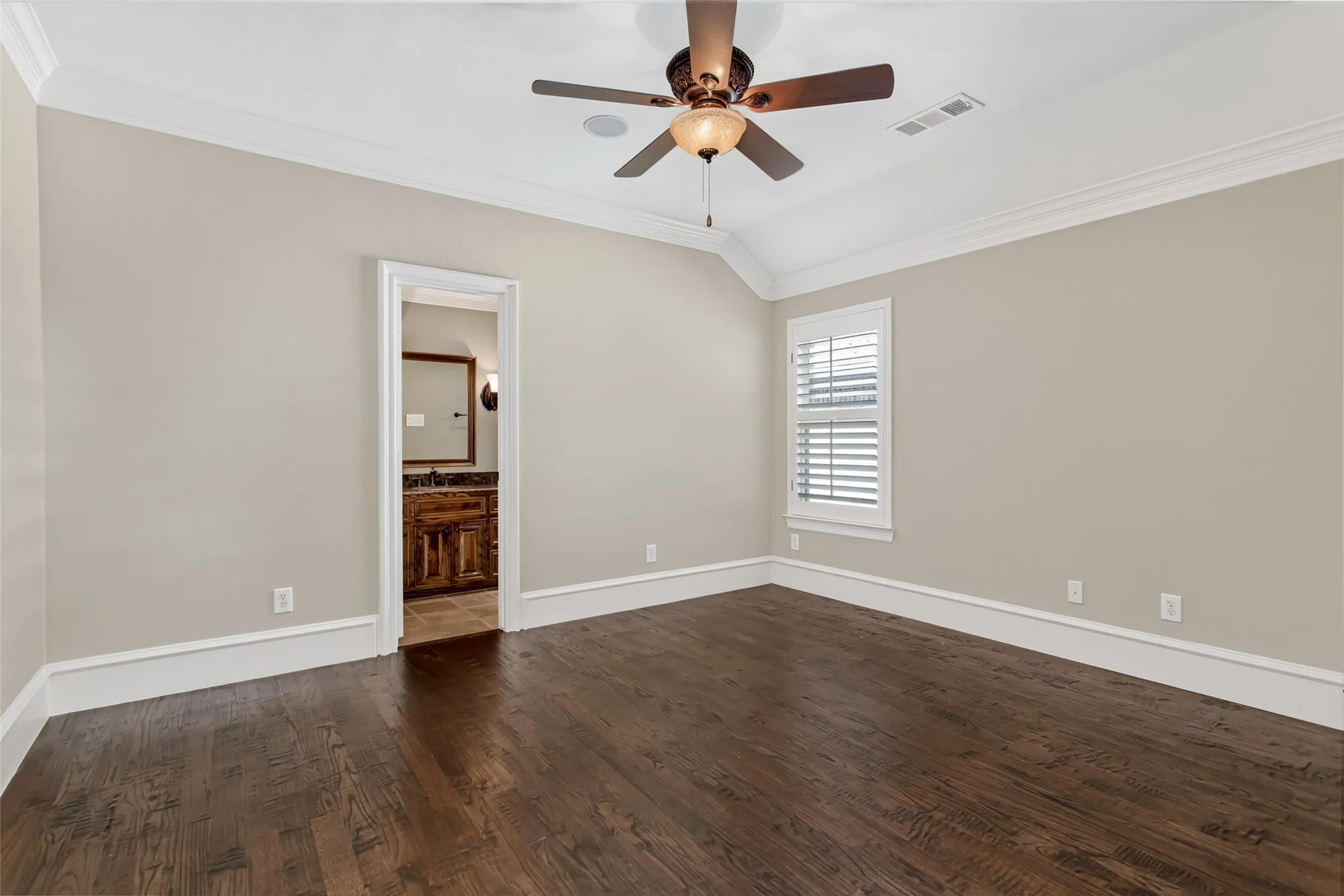Privately situated away from the other secondary bedrooms, this spacious upstairs retreat offers hardwood flooring, crown molding, a tray ceiling, ceiling fan, and a private en-suite bathroom—ideal for guests, multigenerational living, or an older child seeking additional​​‌​​​​‌​​‌‌​‌‌​​​‌‌​‌​‌​‌​​​‌​​ privacy.