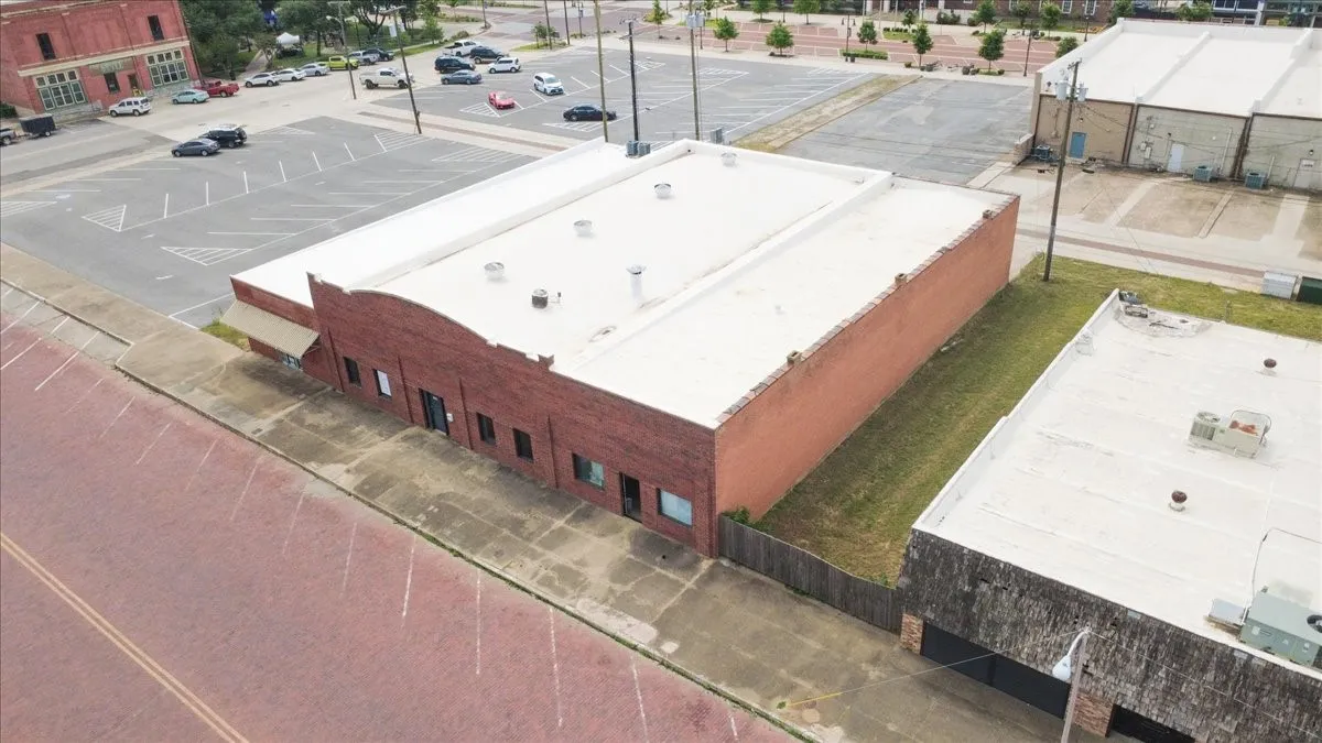 Brick commercial building with a flat roof and multiple windows
